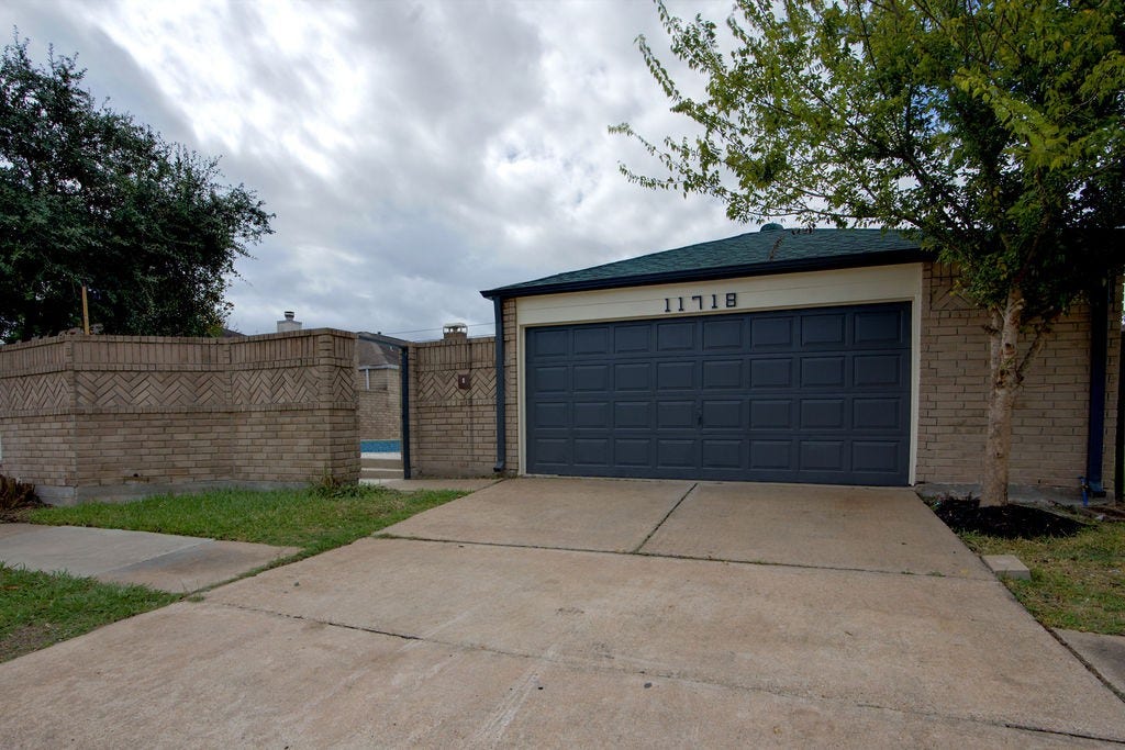 Charming home with a spacious driveway and a sleek two-car garage, complemented by a private fenced yard.