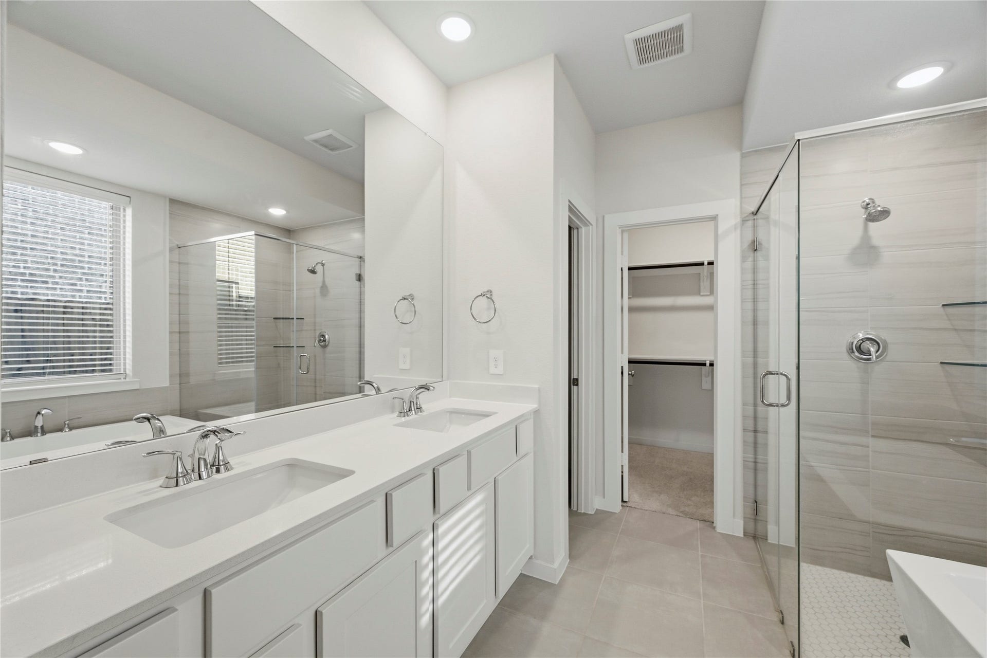 29821 Ellwood Lane, Fulshear, TX 77441 Another view of the primary ensuite highlighting the dual vanity, oversized walk-in shower, and spacious walk-in closet.