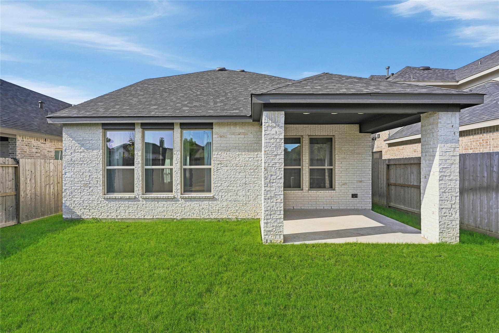 29821 Ellwood Lane, Fulshear, TX 77441 Fully fenced backyard with a covered patio, offering plenty of space for outdoor entertaining and everyday enjoyment.