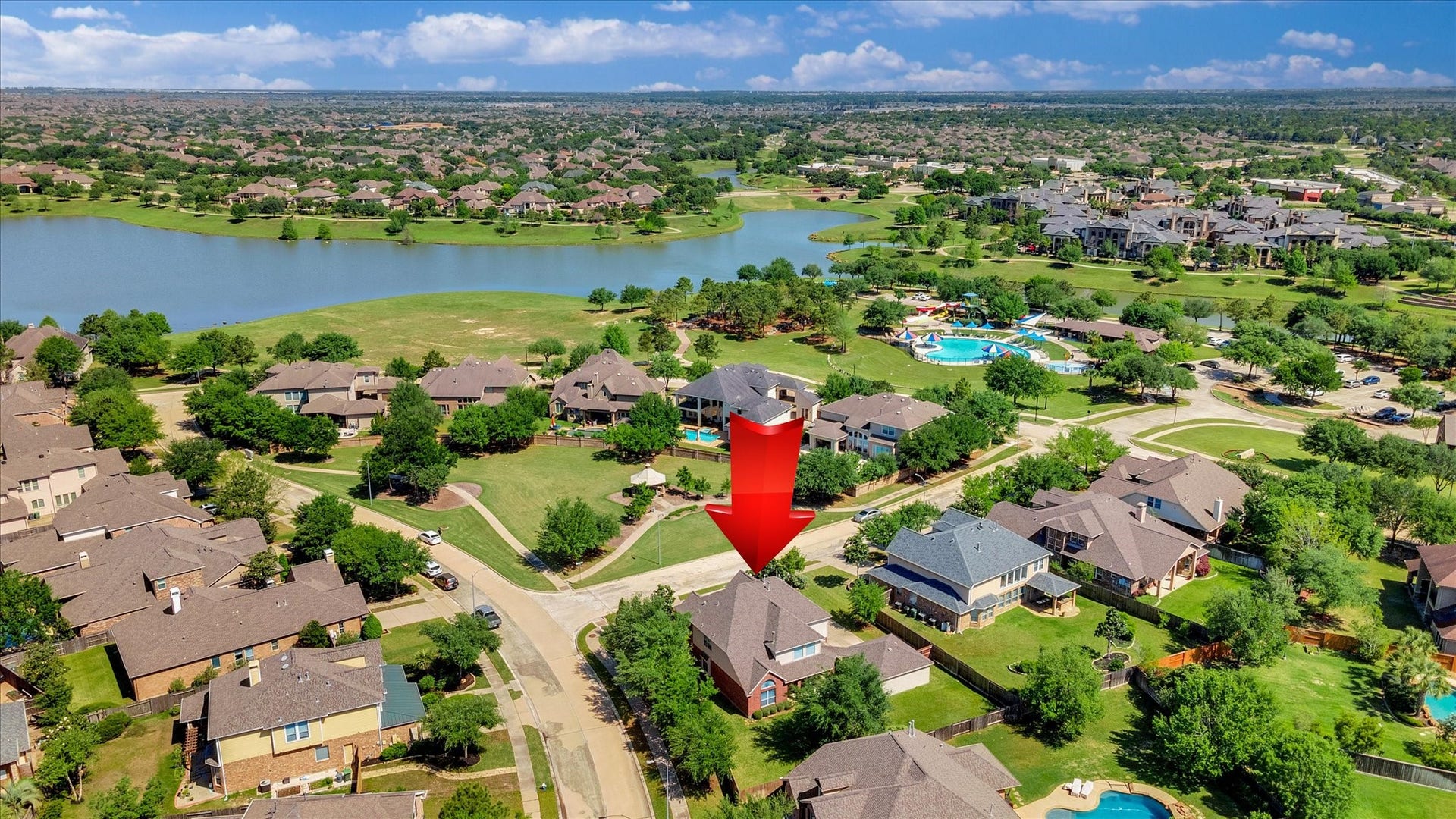 Spacious suburban home in a picturesque neighborhood, featuring tree-lined streets and a nearby lake. The community includes a pool and offers a serene, family-friendly environment.