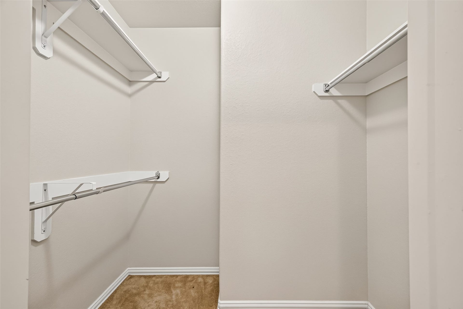 8155 Laughing Falcon Trail, Conroe, TX 77385 Walk-in closet offering multiple hanging rods, upper shelving, and separate storage sections.