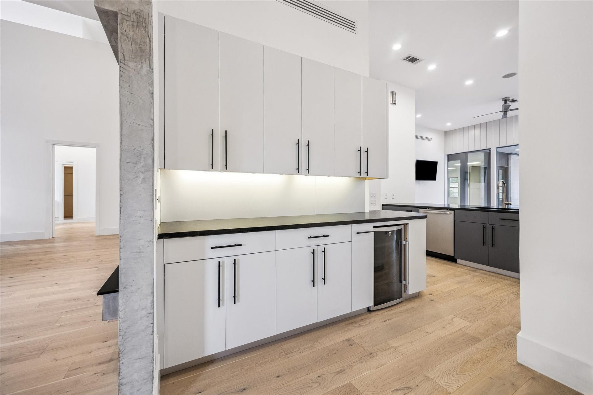 1601 Pine Chase Drive, Houston, TX 77055 The perfect in-between: a stylish butlers pantry connects the dining room to the kitchen w/ ample serving space & a beverage fridge. Powder bath to the right