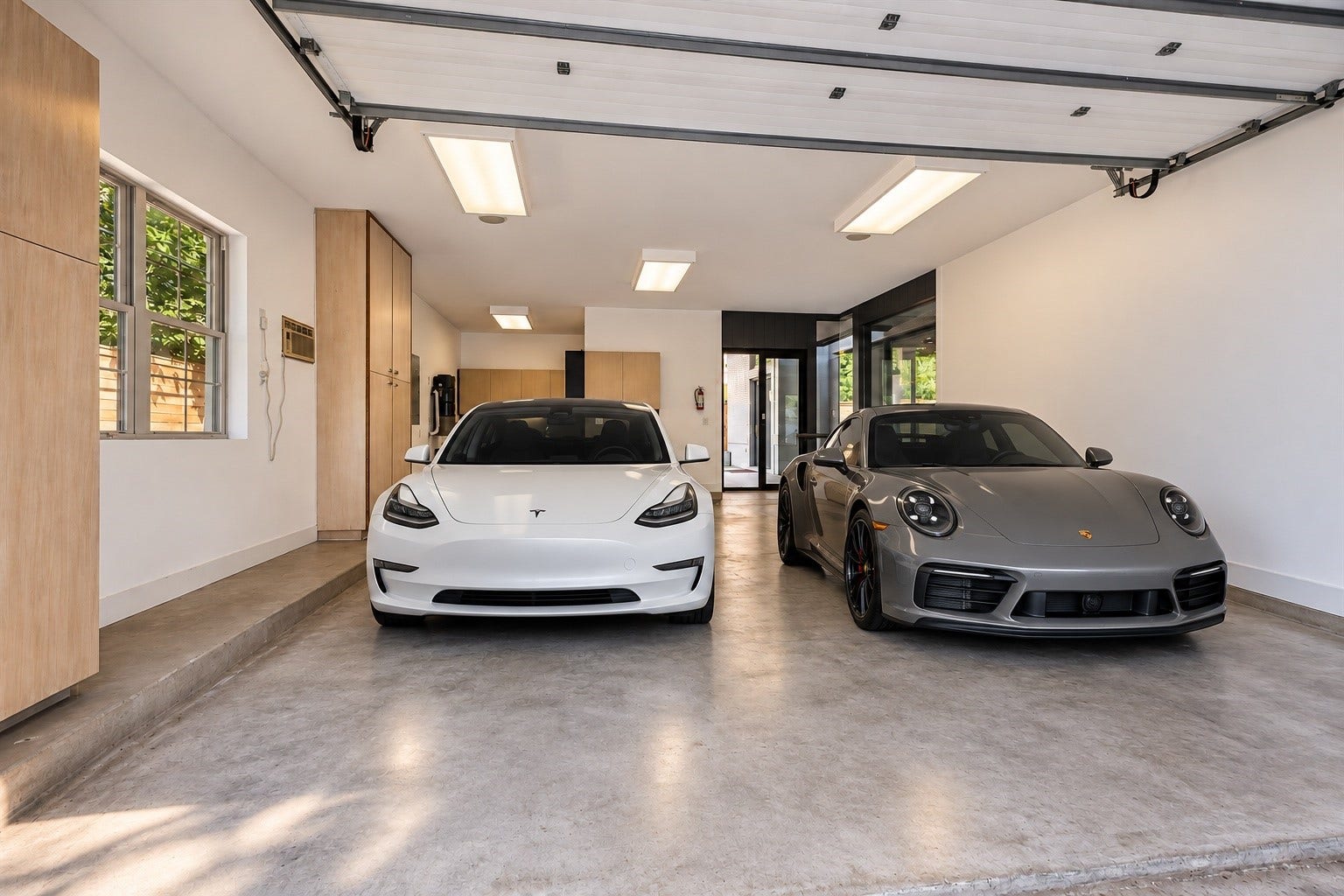 1601 Pine Chase Drive, Houston, TX 77055 For the car enthusiast! Polished concrete, custom built-ins & expansive glass doors create a sleek showroom-style garage. Virtually staged