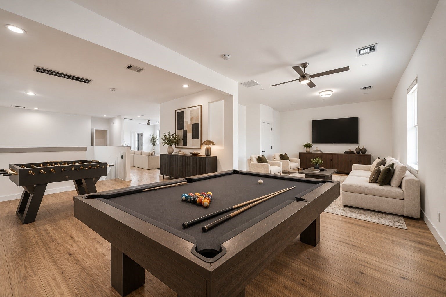 1601 Pine Chase Drive, Houston, TX 77055 Expansive game room with dedicated spaces for billiards, foosball, and lounging. Ideal for entertaining on a large scale. Virtually staged
