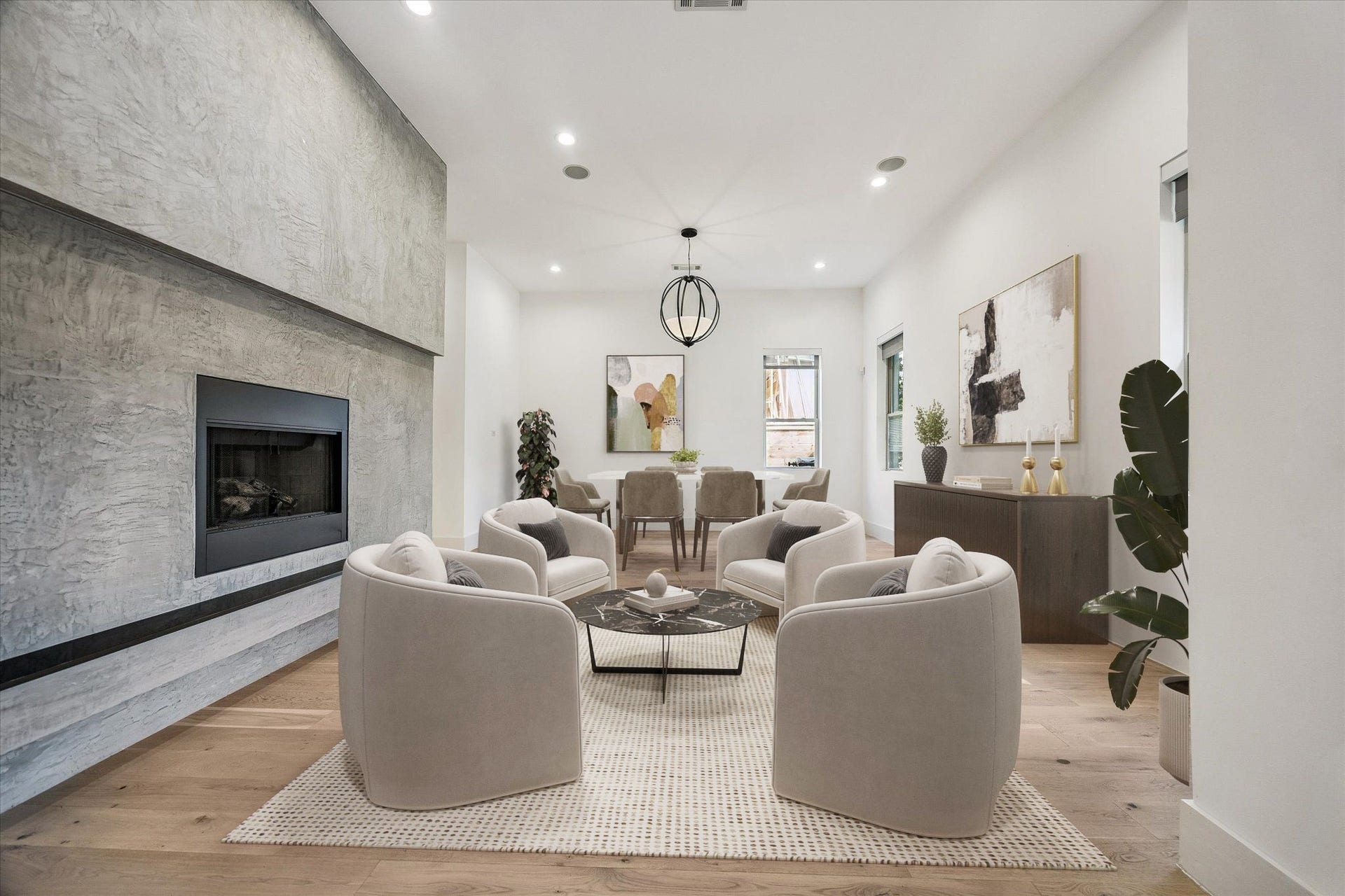 1601 Pine Chase Drive, Houston, TX 77055 Spacious formal living space framed by a modern gas fireplace, globe pendant lighting, and warm natural wood floors. Virtually staged