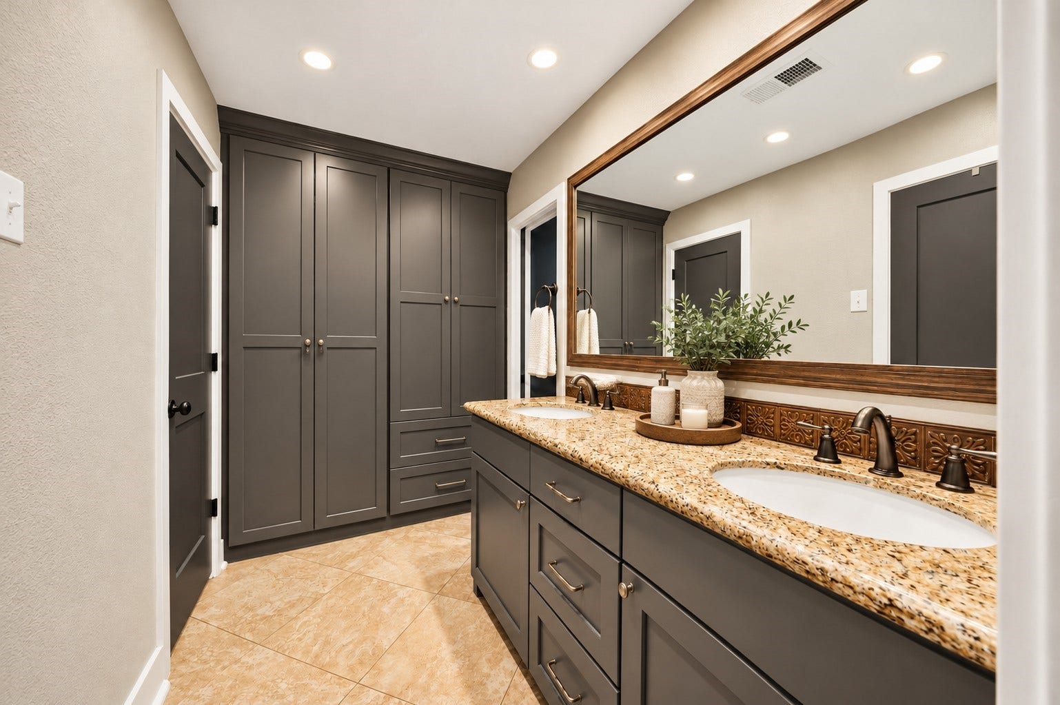 10818 Creektree Drive, Houston, TX 77070 Bathroom with Double Vanity (Virtually Staged)
Spacious bathroom showcasing dual sinks, granite countertops, modern gray cabinetry, an oversized framed mirror, and extensive built-in storage. A perfect blend of style and everyday functionality.
