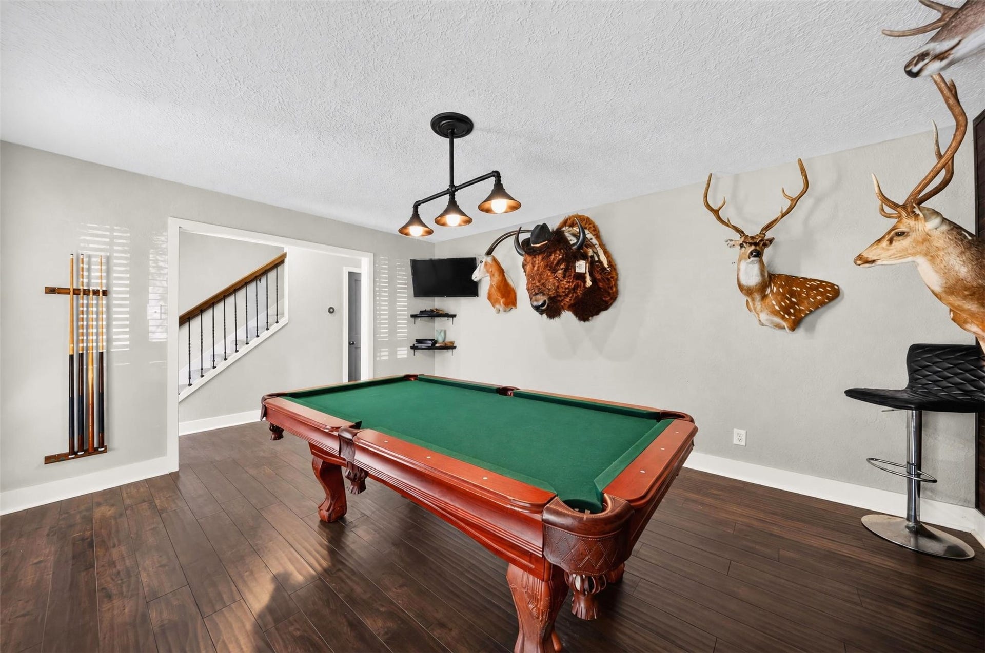 10818 Creektree Drive, Houston, TX 77070 Billiard Room: Impressive billiard room offering ample space for recreation and entertaining, with rich wood-look flooring and convenient access to the main living areas.