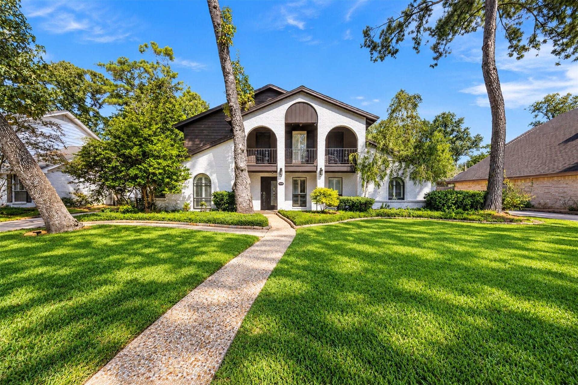 10818 Creektree Drive, Houston, TX 77070 Front Exterior
Beautiful two-story home showcasing timeless painted brick, distinctive arched architecture, an upper-level balcony, mature trees, and beautifully maintained landscaping that creates impressive curb appeal.
