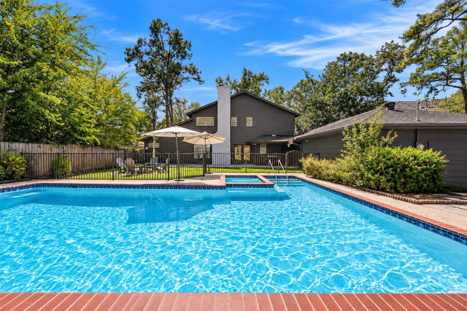 10818 Creektree Drive, Houston, TX 77070 Pool & Spa: Enjoy resort-inspired outdoor living with a private in-ground pool, adjoining spa, and expansive poolside areas designed for relaxation and entertaining.