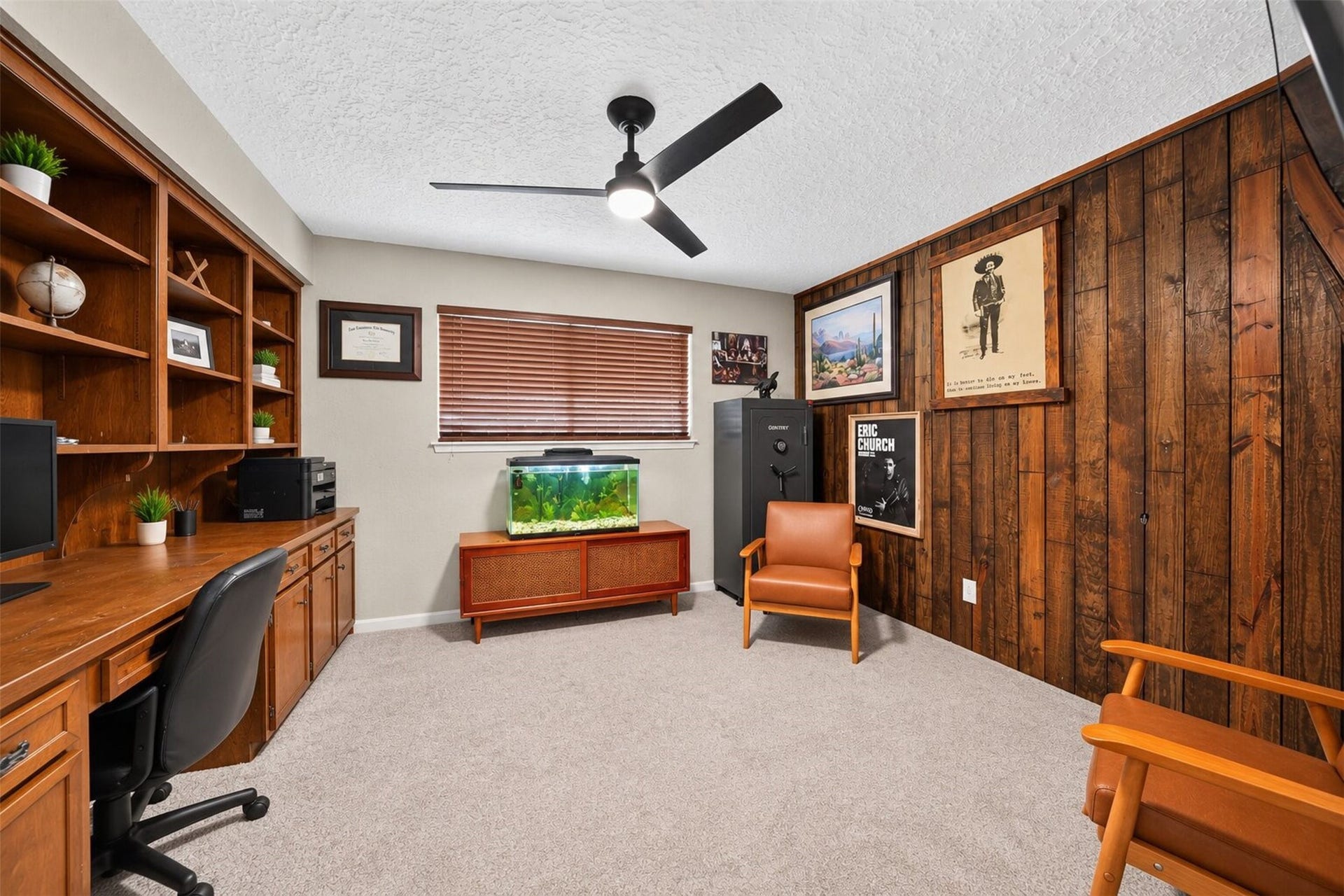 10818 Creektree Drive, Houston, TX 77070 Home Office: Dedicated home office featuring extensive built-in wood cabinetry, shelving, and workspace, complemented by warm wood accents.