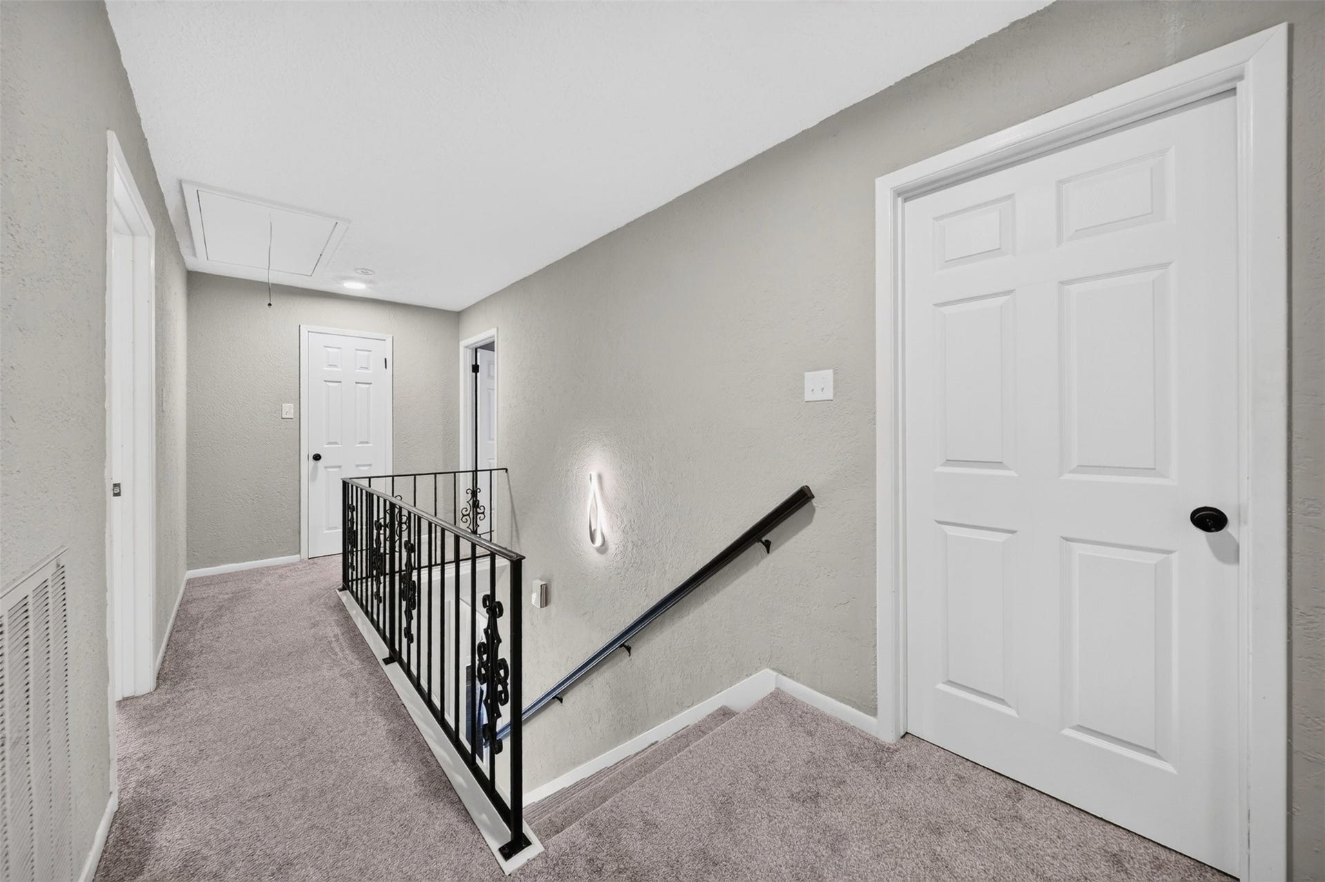 10818 Creektree Drive, Houston, TX 77070 Upstairs Landing / Hallway
Upstairs landing featuring neutral finishes, carpeting, decorative wrought-iron railing, and convenient access to the second-floor rooms.