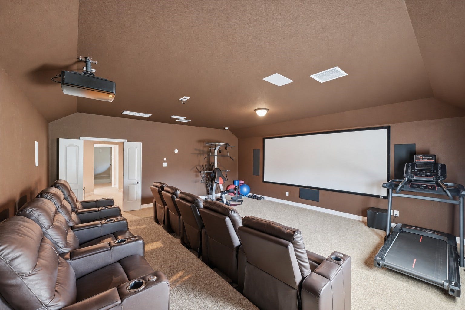 51 S Fremont Ridge Loop, Spring, TX 77389 The expansive media room features tiered theater seating and a 158-inch screen that brings the cinema experience home.