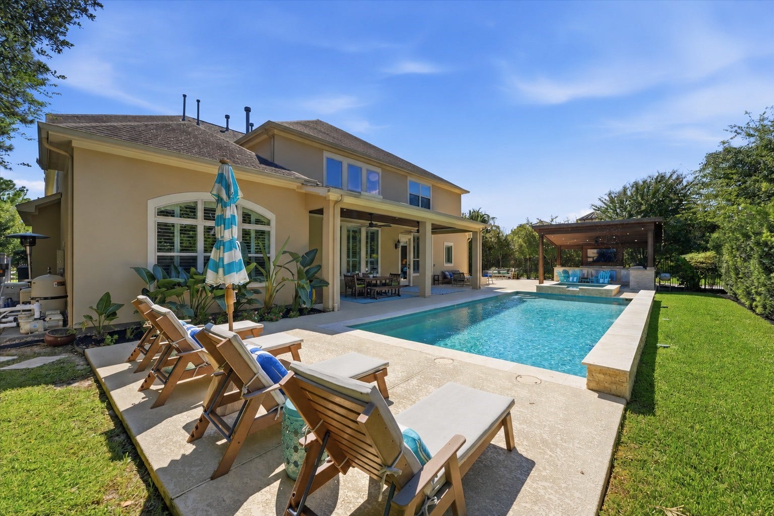 51 S Fremont Ridge Loop, Spring, TX 77389 The pool and spa anchor this outdoor retreat, with generous decking and two covered patios for lounging, dining, and entertaining.