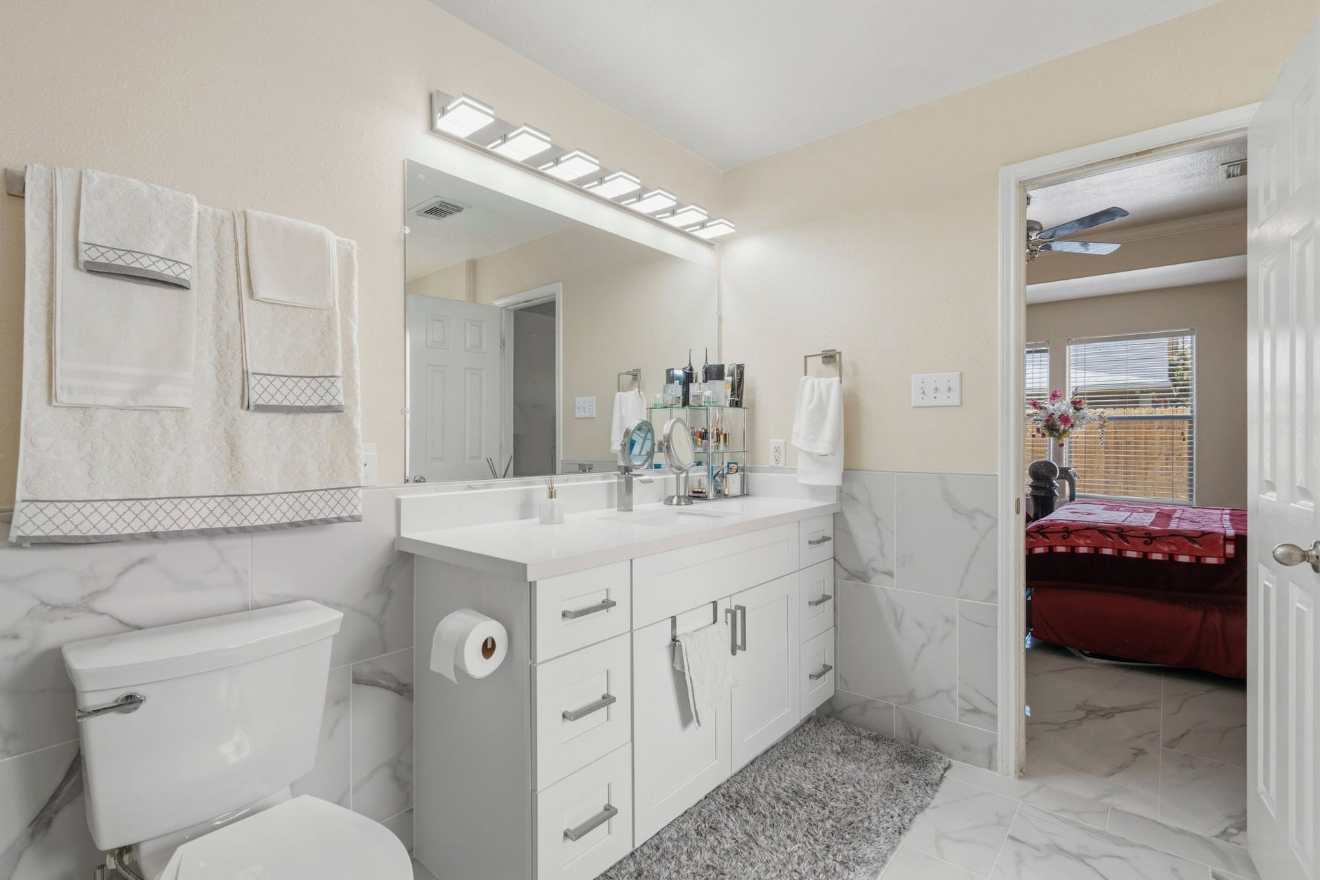 19302 Christine Crossing Drive, Richmond, TX 77407 The remodeled primary bath includes a long vanity with generous storage, bright lighting and an open connection to the bedroom.