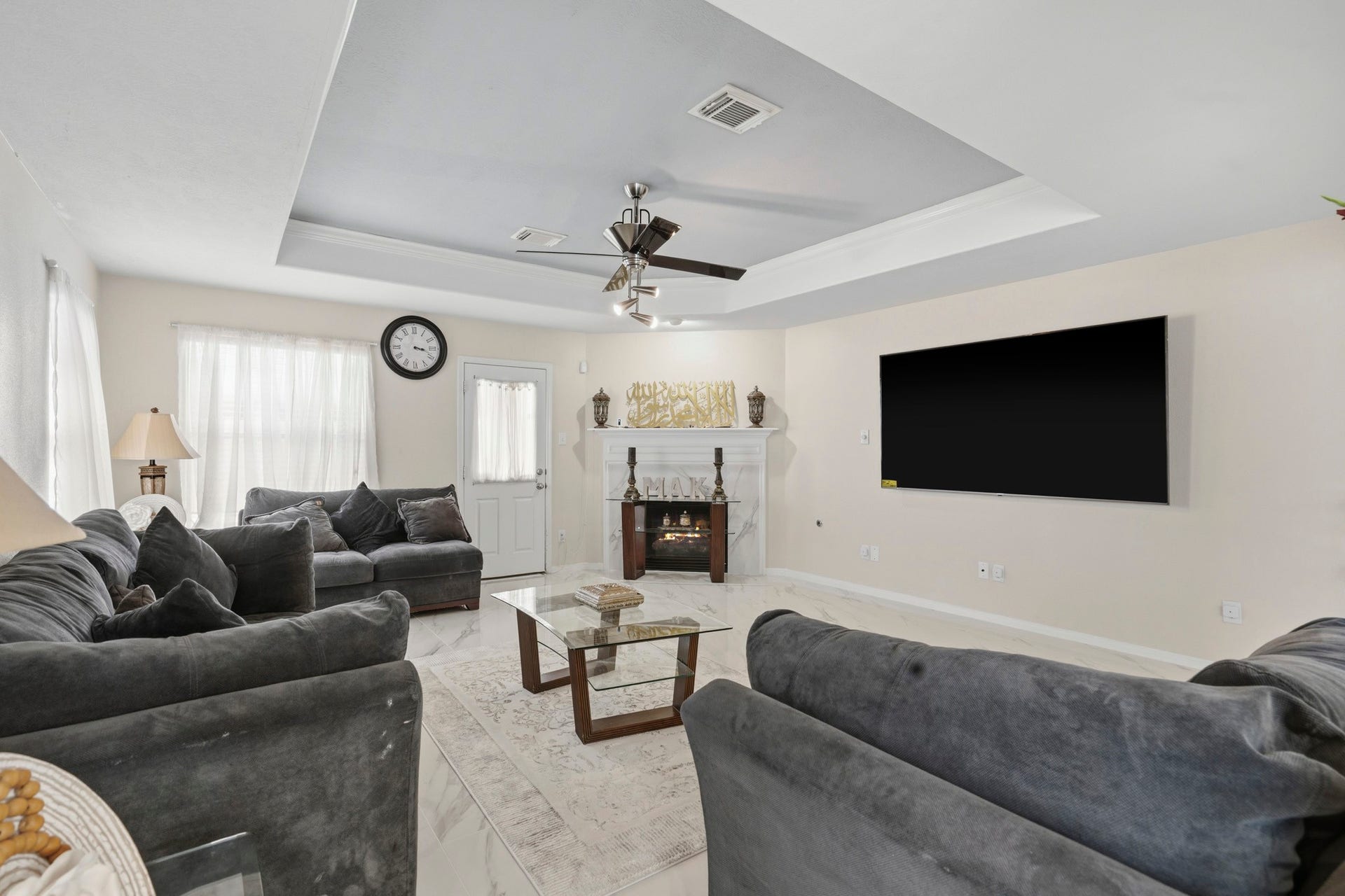 19302 Christine Crossing Drive, Richmond, TX 77407 The spacious family room offers plenty of room to relax and gather, while the recessed ceiling and open layout add an airy feel.
