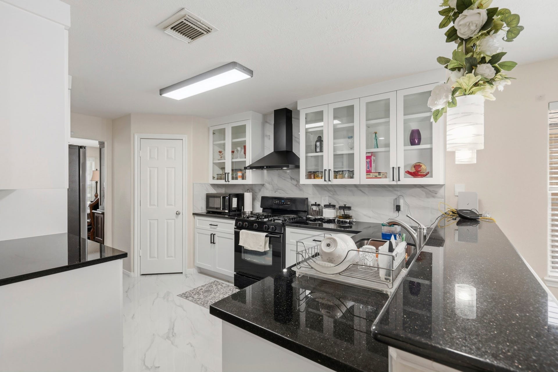 19302 Christine Crossing Drive, Richmond, TX 77407 The remodeled kitchen pairs crisp white cabinetry, granite countertops, abundant workspace and a large island for prep and serving.