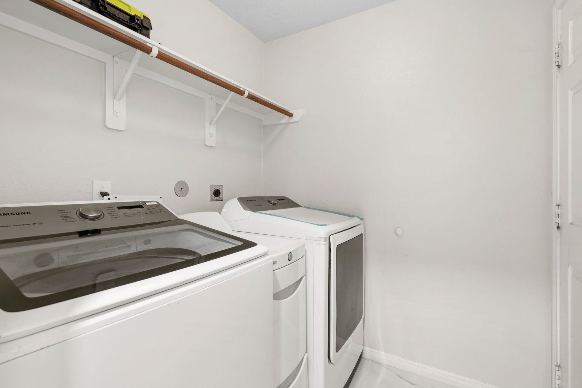 19302 Christine Crossing Drive, Richmond, TX 77407 The convenient indoor utility room provides space for a full-size washer and dryer, along with shelving for laundry supplies.