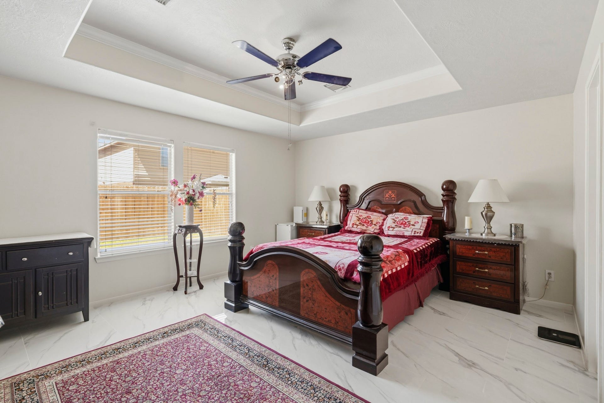 19302 Christine Crossing Drive, Richmond, TX 77407 The spacious primary bedroom offers a recessed ceiling, ceiling fan and plenty of room to create a relaxing personal retreat.
