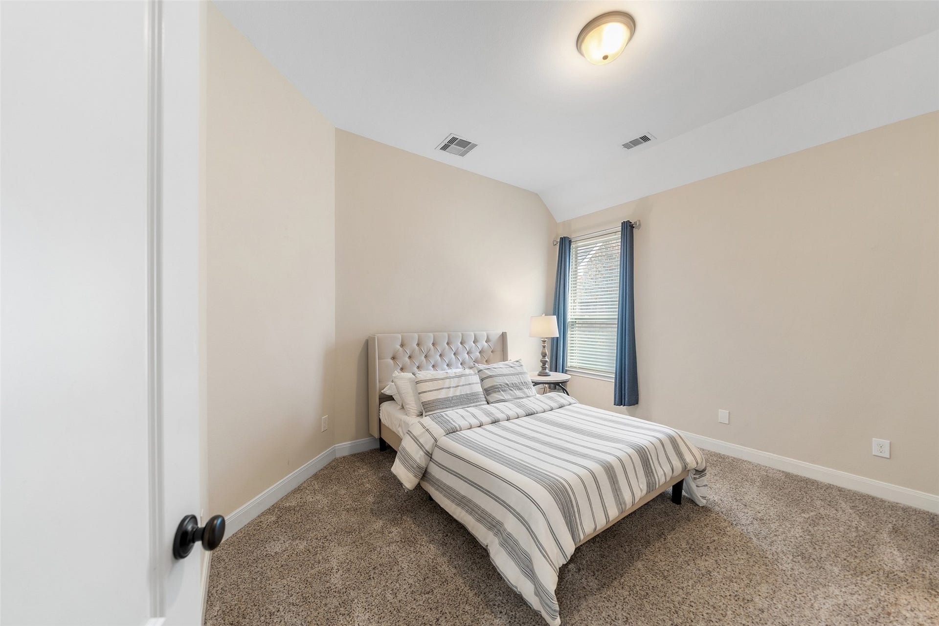 34 Danby Place, The Woodlands, TX 77375 This cozy bedroom offering natural light and a serene atmosphere, with an en-suite bathroom.