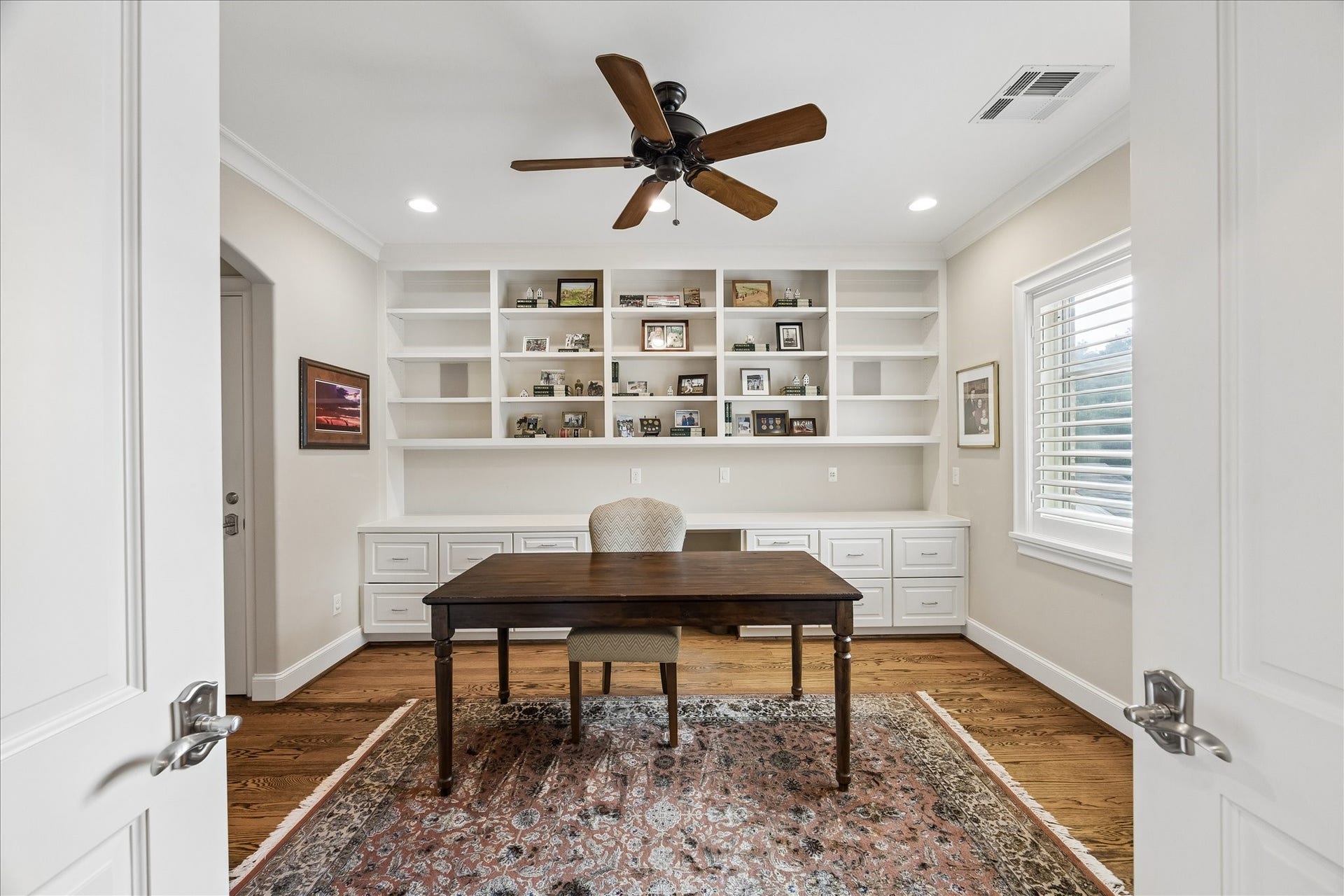Private home office that has, two large closets and doors leading into the primary bedroom.