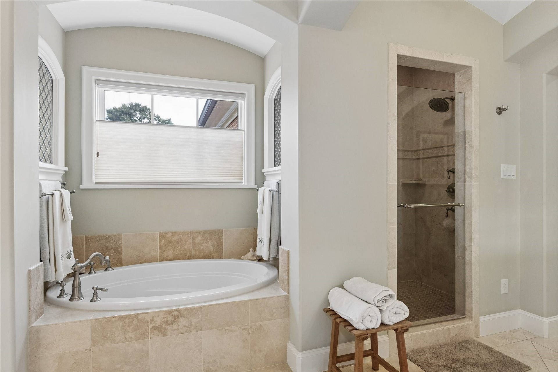 Soaking tub with privacy window covers that still provide natural light primary bath.