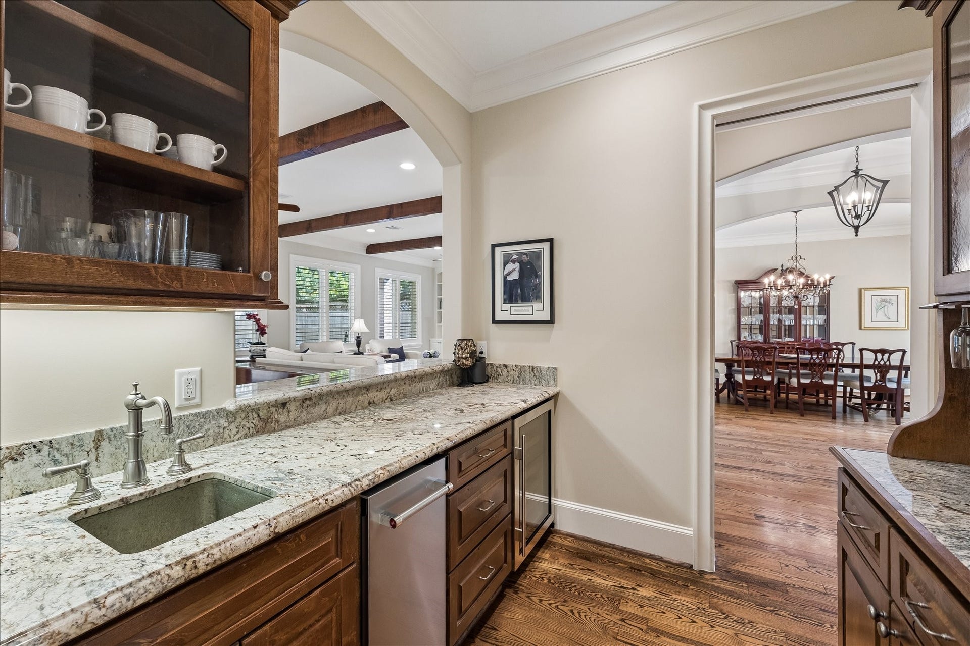 Wet bar with ice maker, sink and beverage refrigerator.