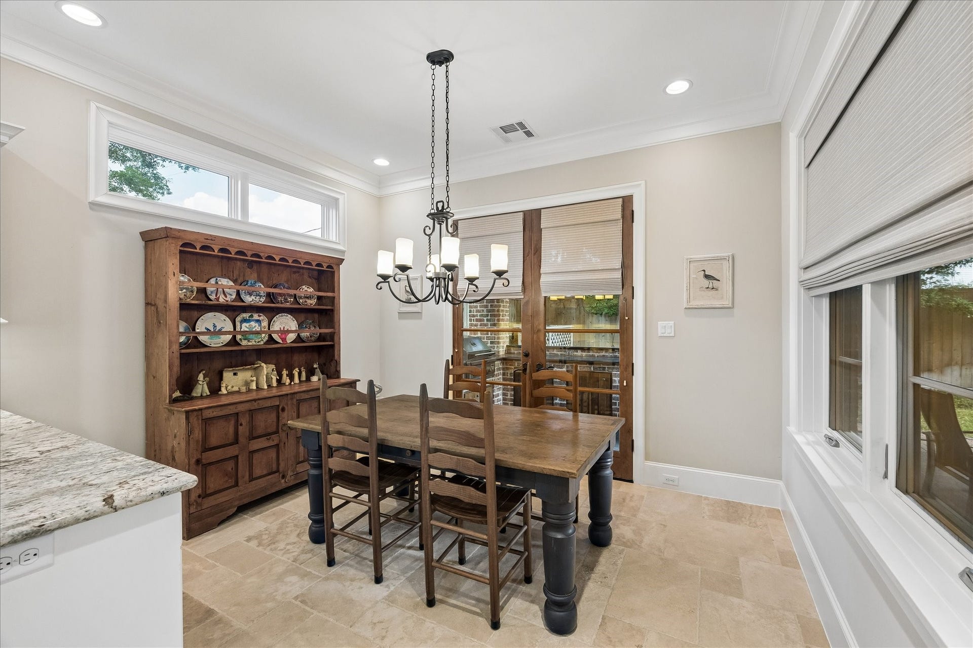 Breakfast room with French doors leading to the covered, outdoor kitchen and patio.