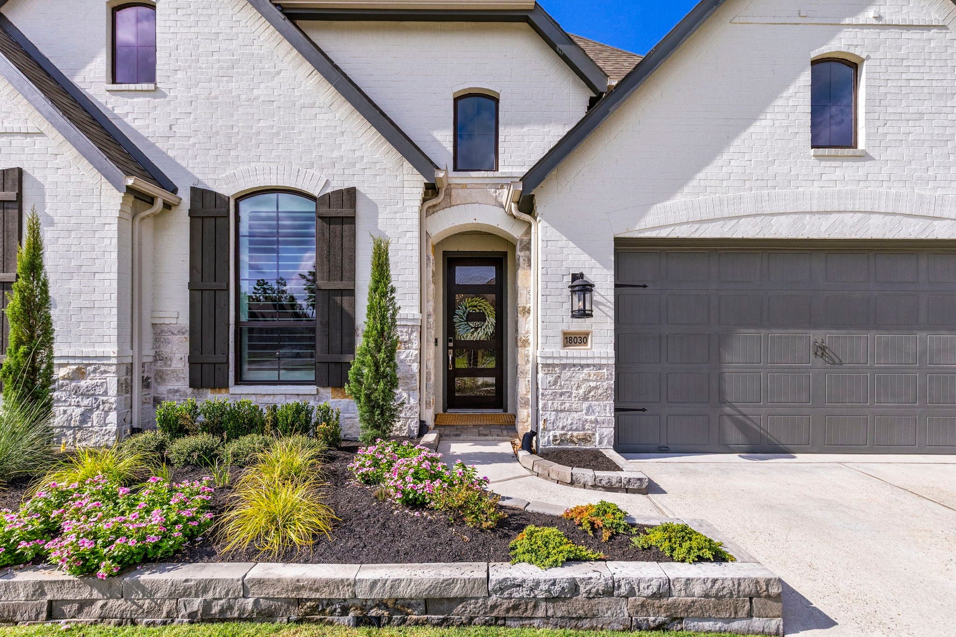 18030 Blu Terrace Drive, Conroe, TX 77302 Low-maintenance landscaping and clean edging frame the front walk, and the attached garage offers everyday convenience. It is the kind of entrance that says, Yes, I have good taste, without saying a word.