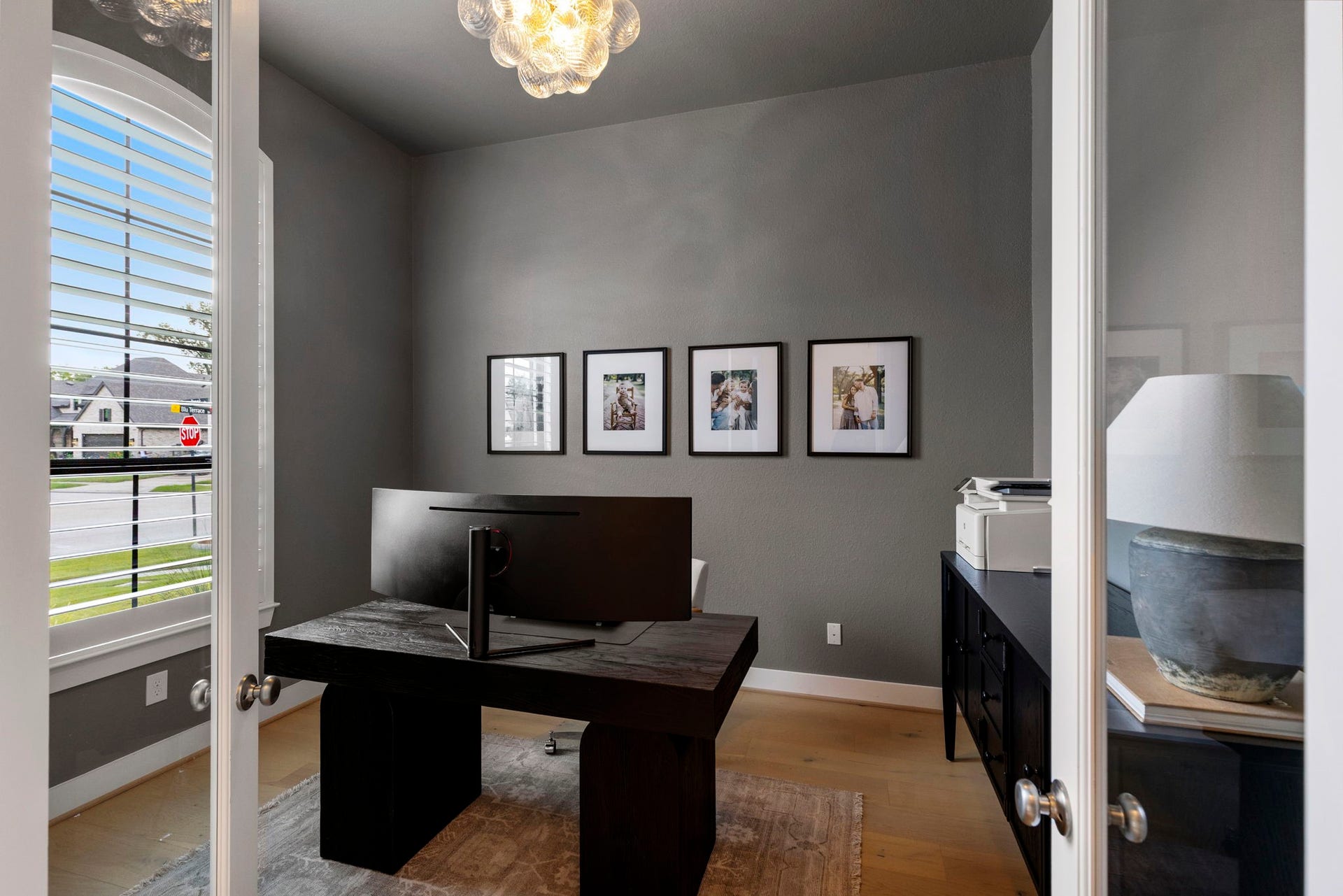 18030 Blu Terrace Drive, Conroe, TX 77302 Private study with plantation shutters, hardwood floors, and designer lighting for a bright, polished workspace.