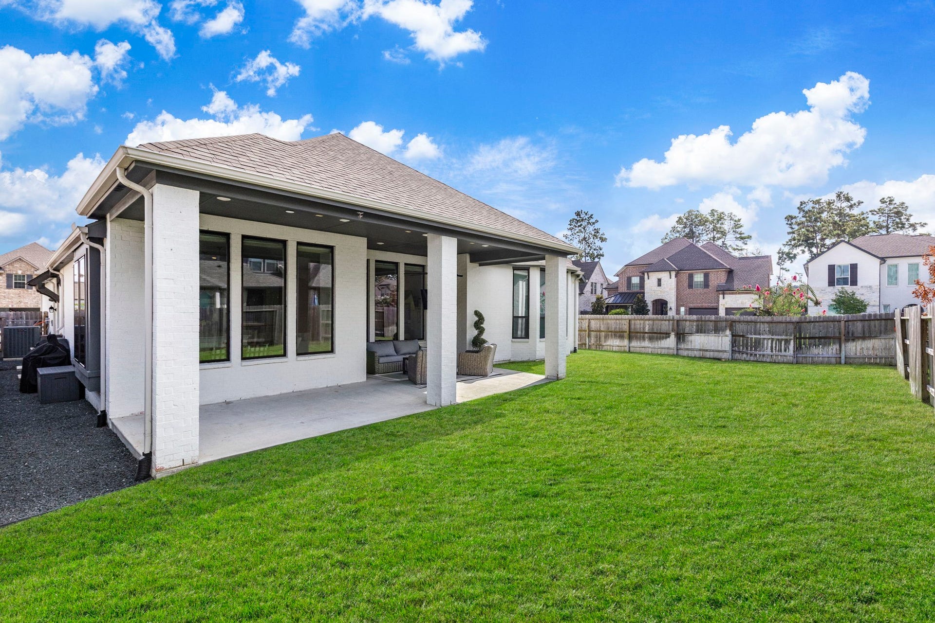 18030 Blu Terrace Drive, Conroe, TX 77302 Expansive fenced backyard with lush lawn, perfect for outdoor entertaining and everyday play.