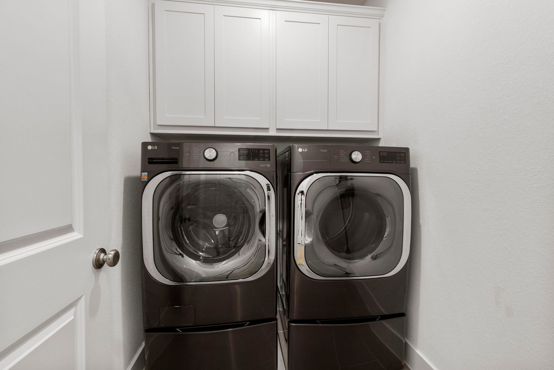 18030 Blu Terrace Drive, Conroe, TX 77302 Streamlined laundry room with crisp upper cabinetry and easy-access layout for everyday convenience.