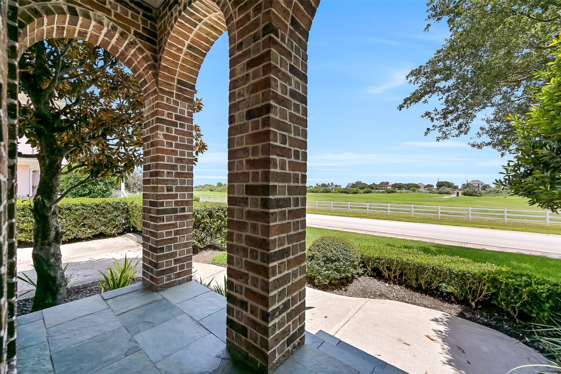 6 Barque Lane, Galveston, TX 77554 This East-facing covered porch enjoys vistas of the Moody Gardens Golf Course.