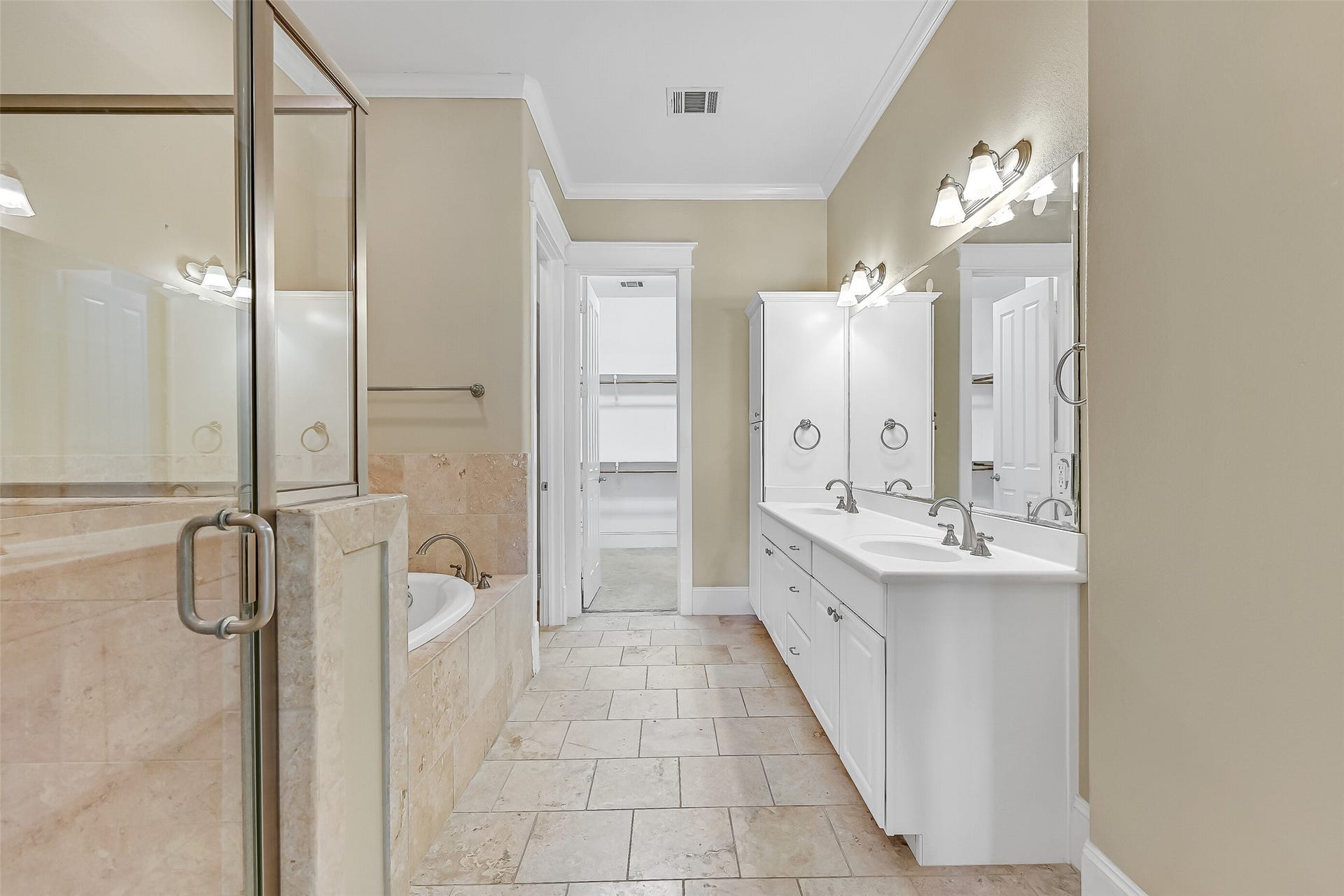 6 Barque Lane, Galveston, TX 77554 Primary bath lathed in travertine finishes.