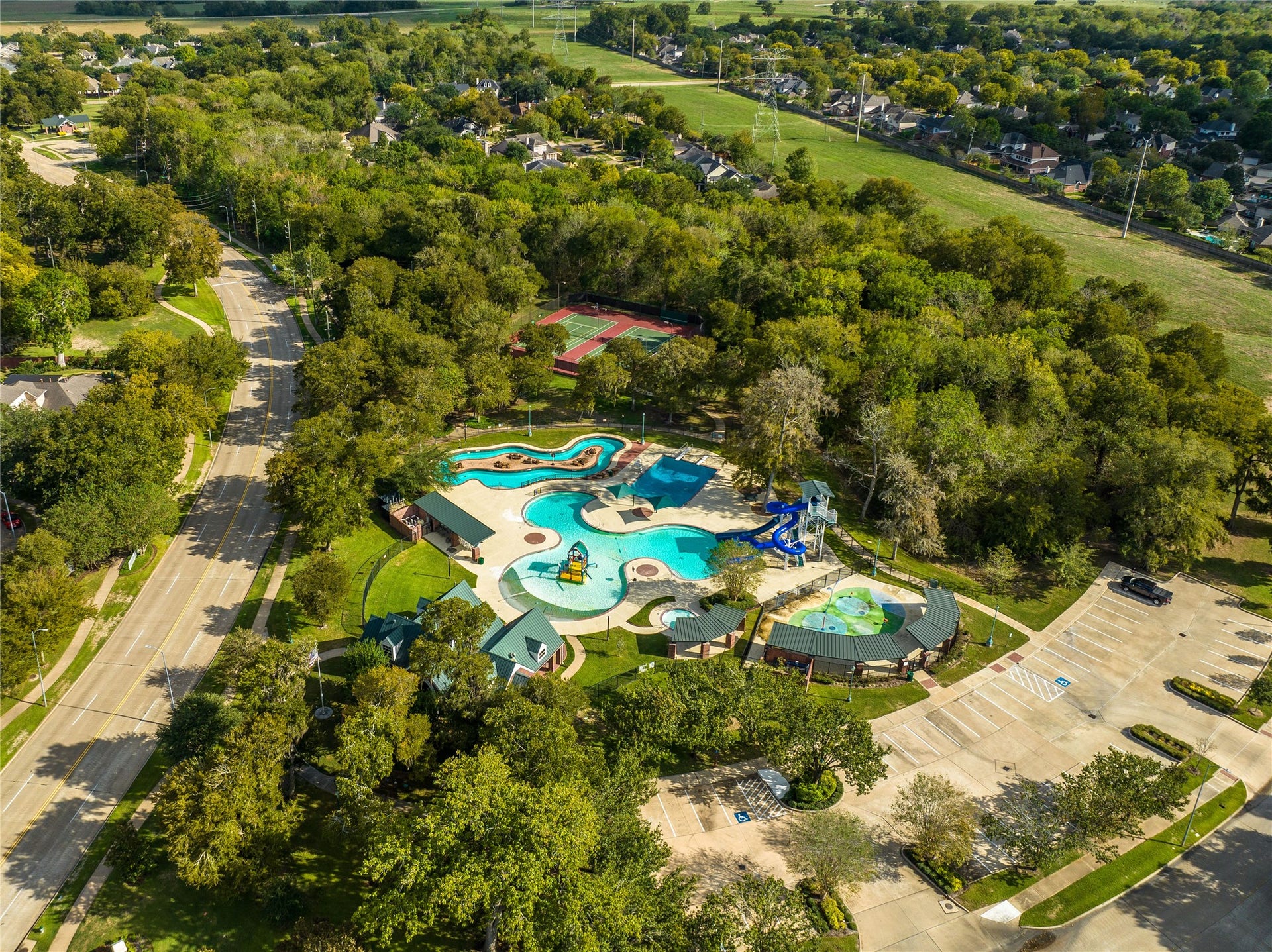 7922 EMERALD HAVEN DRIVE, Sugar Land, TX 77479 FROM KIDDIE SPLASH ZONES AND TOWERING SLIDES TO SHADED LOUNGING AREAS AND SCENIC WALKING TRAILS, THIS AMENITY-RICH AQUATIC COMPLEX OFFERS FUN FOR ALL AGES.