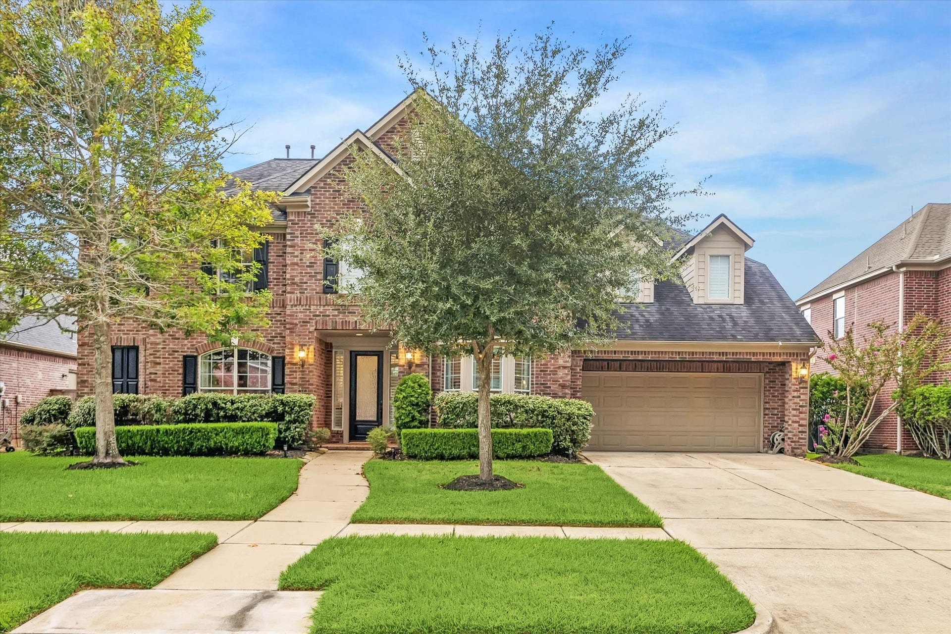 7922 EMERALD HAVEN DRIVE, Sugar Land, TX 77479 TWO-STORY BRICK HOME WITH MATURE TREES, MANICURED LANDSCAPING, AND AN ATTACHED TWO-CAR GARAGE.