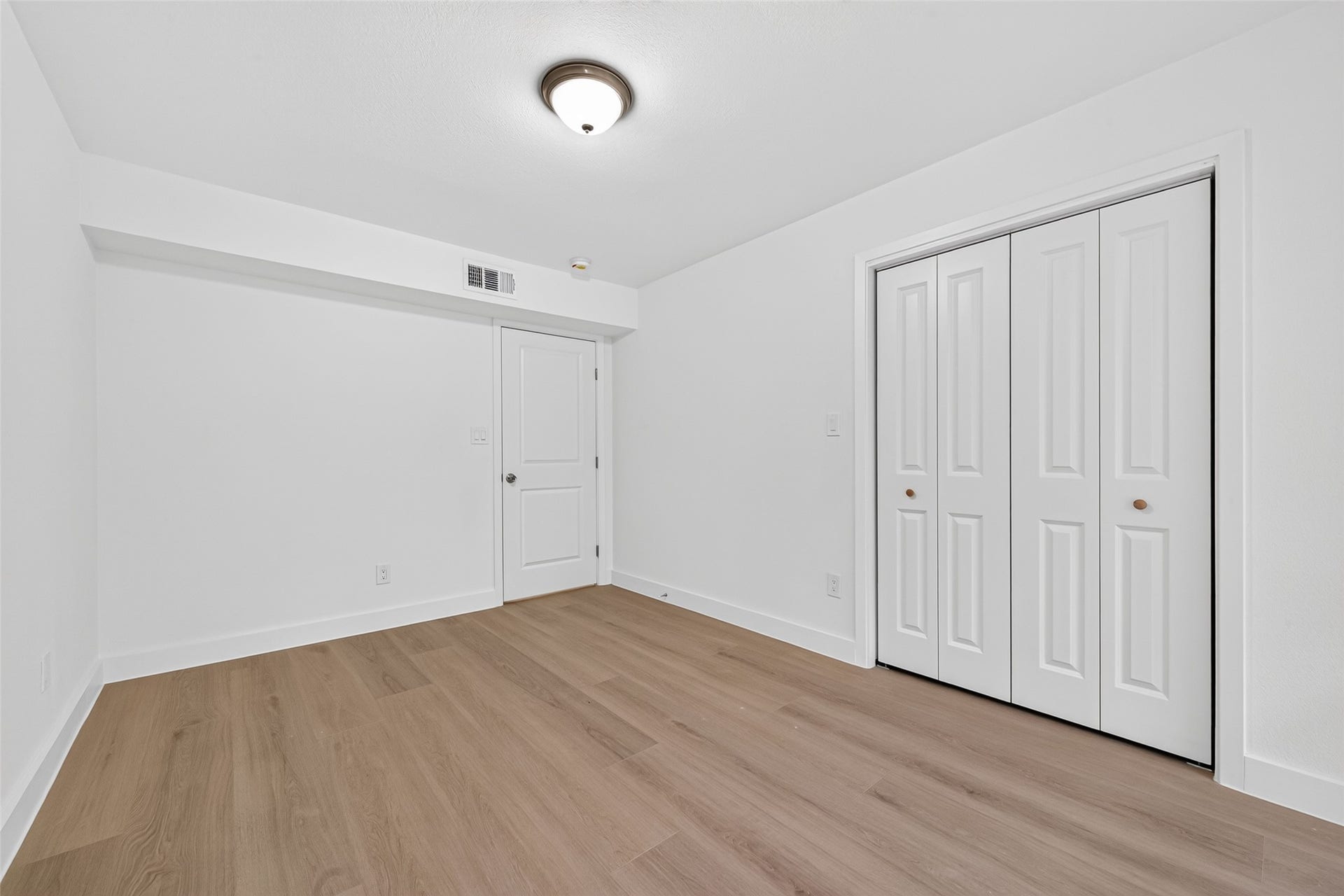4633 Wild Indigo Street, #530, Houston, TX 77027 Versatile second bedroom featuring new laminate flooring, neutral finishes, and a welcoming atmosphere with no carpet.