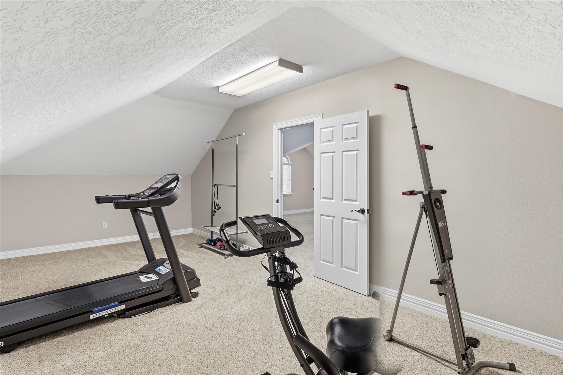 This versatile bonus room offers ample space for a home gym, complete with room for equipment and storage. A great option for those seeking a dedicated fitness space at home.