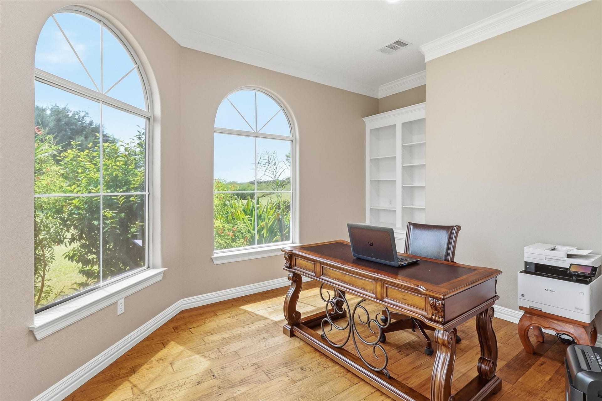 The Study is finely appointed with
wood floors, crown molding and builtin cabinetry with bookcases above.