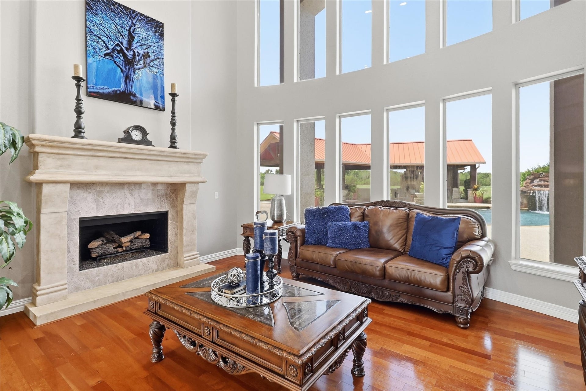 The Living Room is as impressive in
style as it is in purpose. Tucked
behind a massed columned arch, it
offers lovely wood floors, a gas log
fireplace set beneath a massive cast
stone mantel, a Juliet balcony and
two stories of sextuplet windows