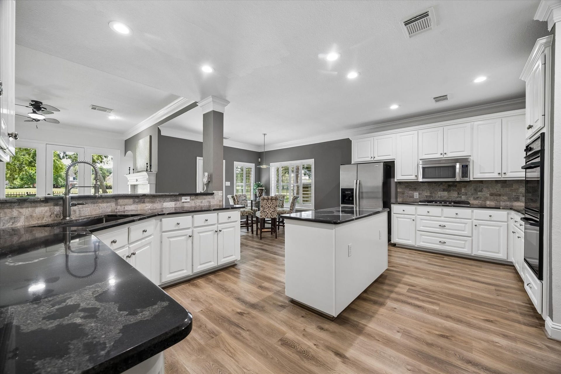 Designer finishes include stainless steel appliances, upgraded hardware and fixtures, a farmhouse sink, and a refrigerator that conveysmaking this beautifully remodeled kitchen move-in ready.