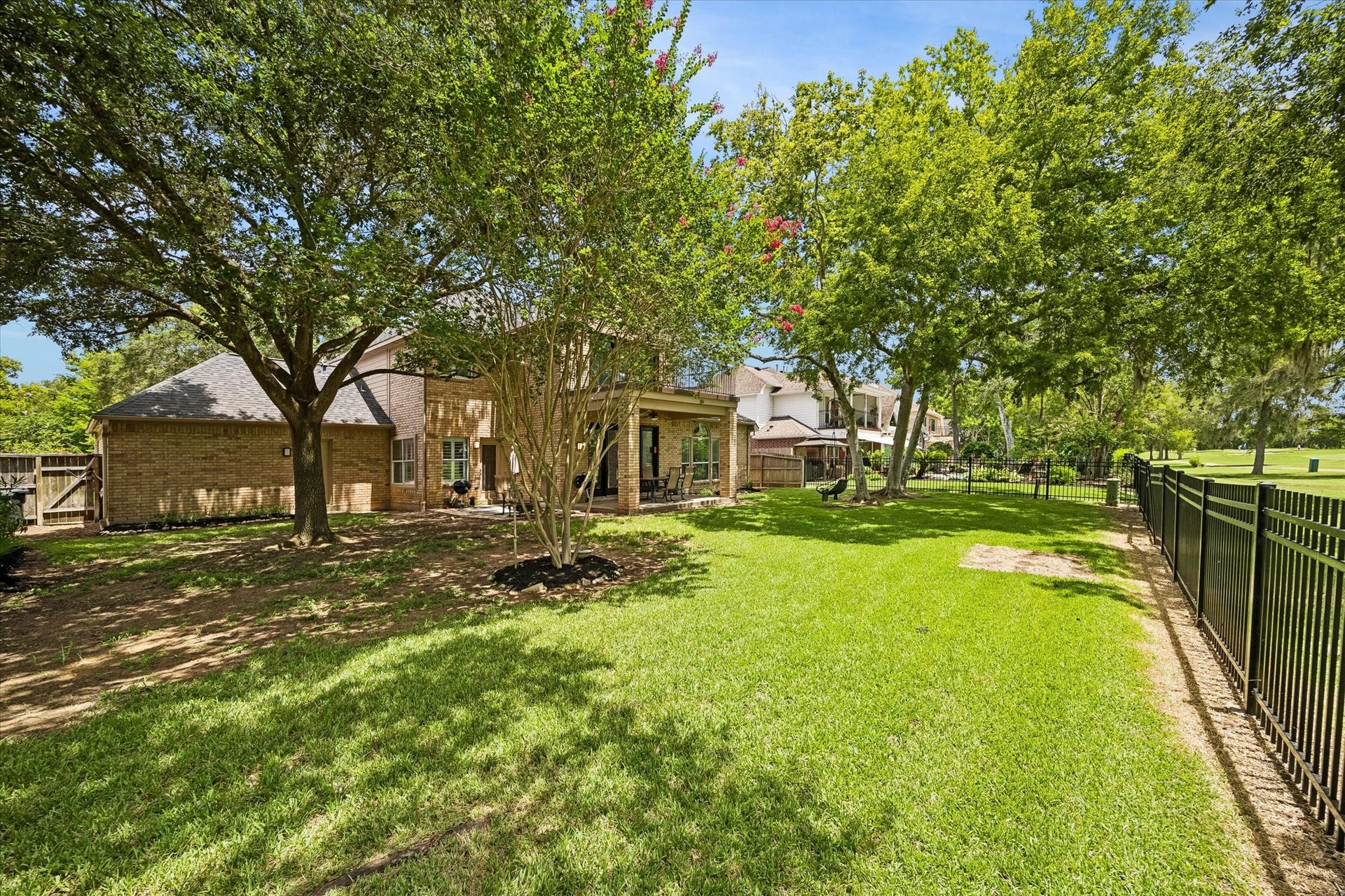 Backing directly to the Greatwood Golf Course, this exceptional property offers a rare combination of privacy, mature trees, and a serene golf course setting.