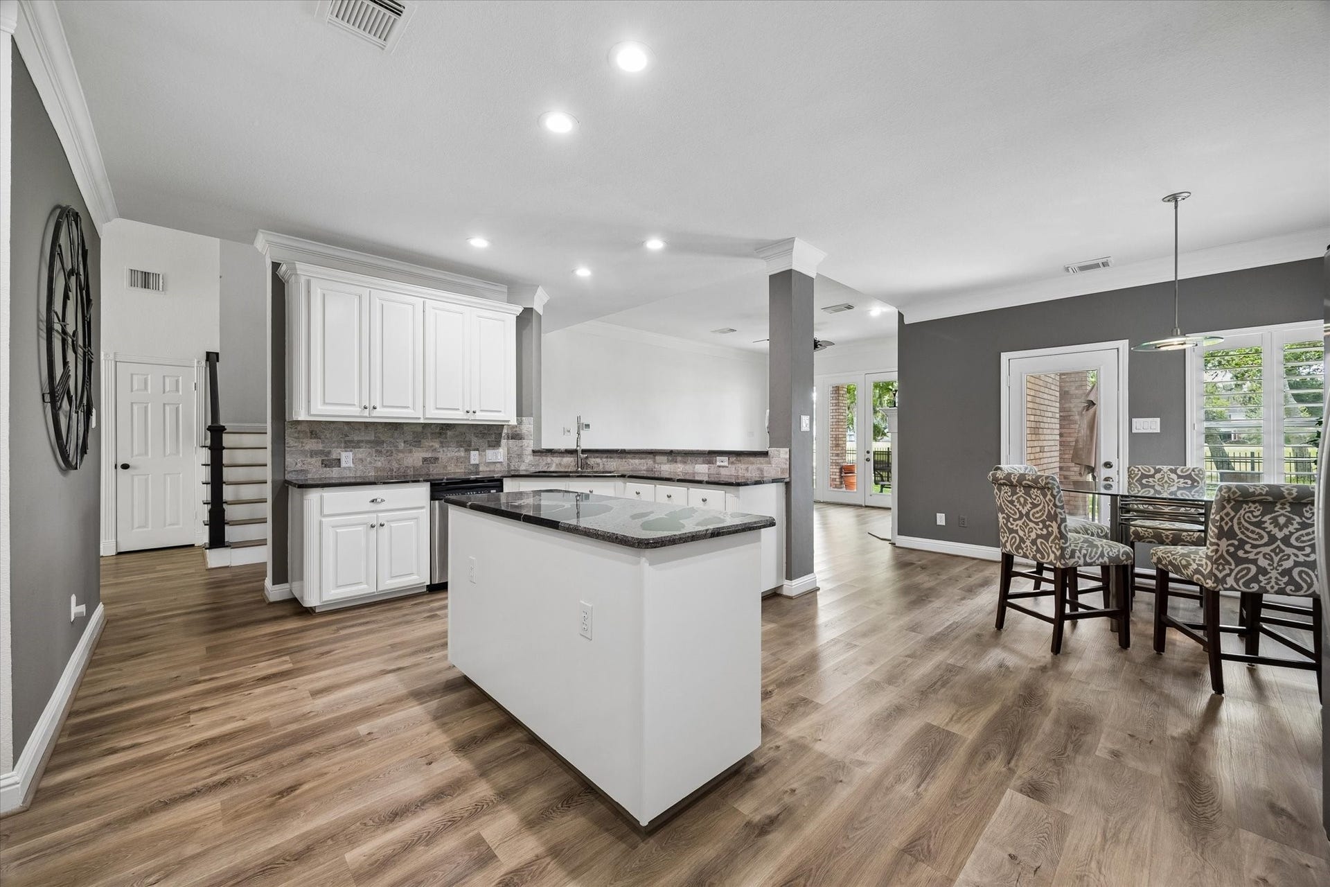 Thoughtfully remodeled, this stunning kitchen boasts an open-concept design, expansive bar seating, and effortless flow for entertaining while remaining connected to the family room and dining areas.