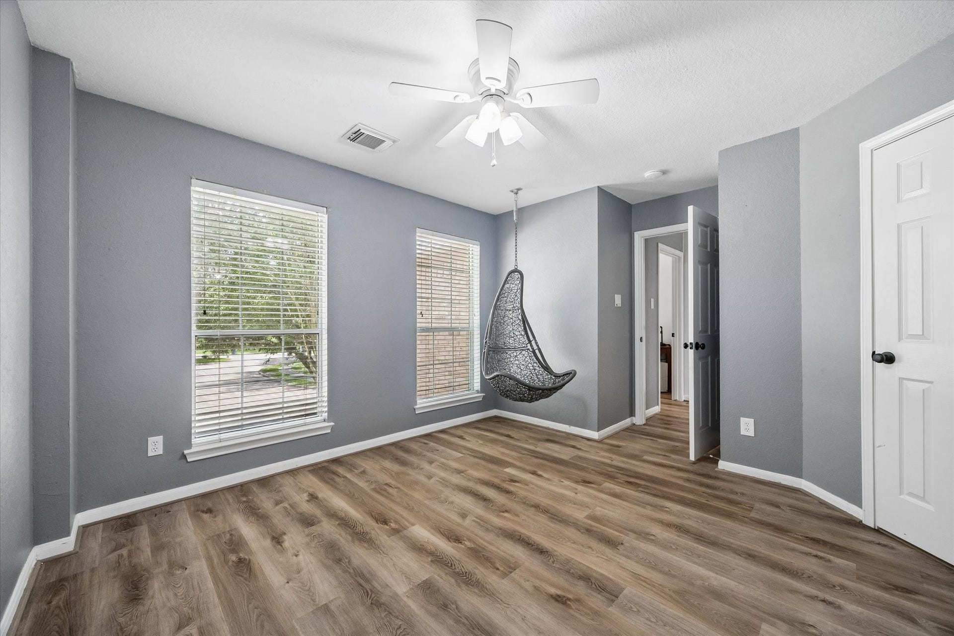 The generously sized secondary bedrooms feature durable luxury vinyl plank flooring, abundant natural light, and the convenience of no carpet throughout the home.