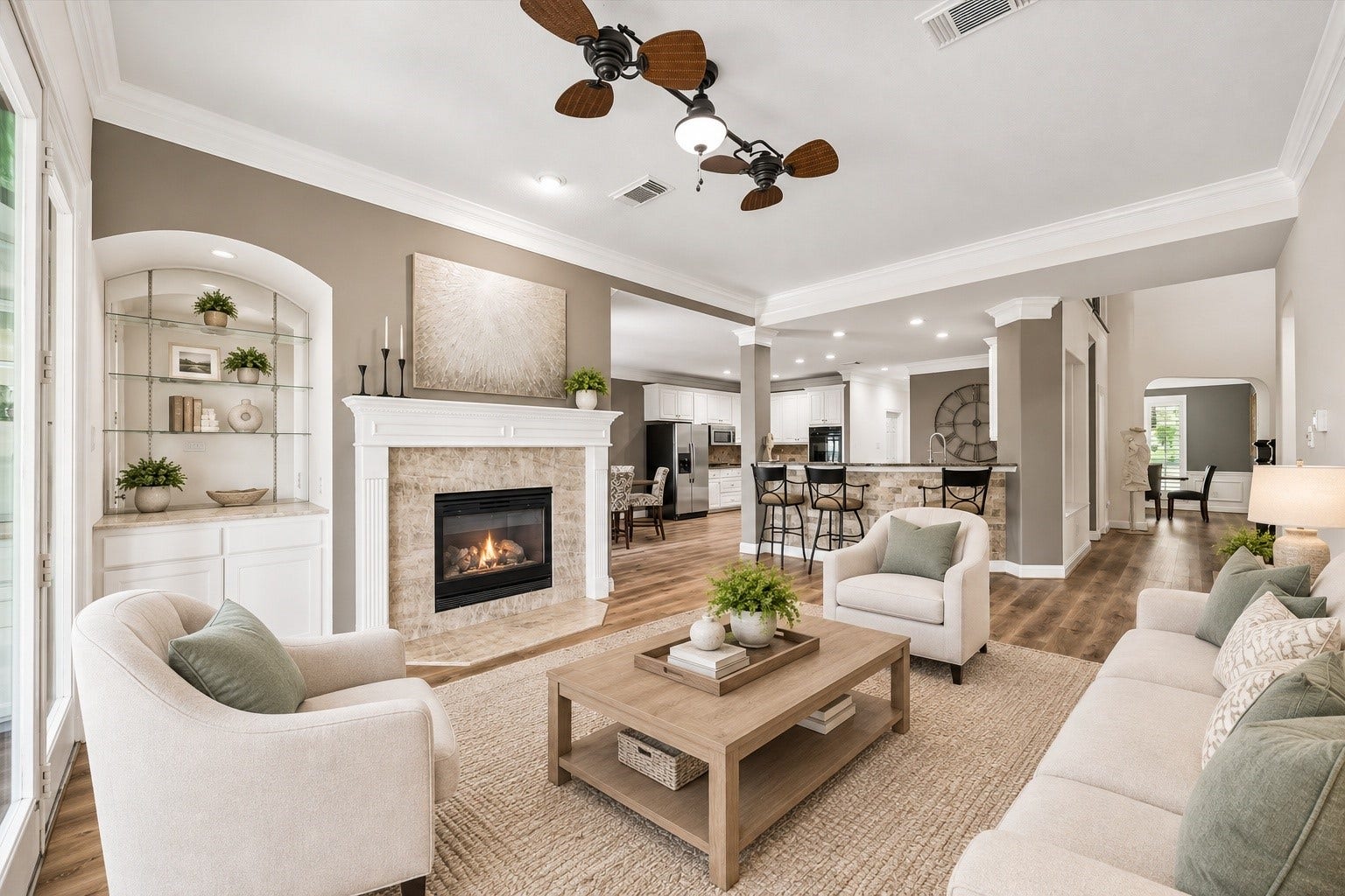 Virtually staged living room highlights the spacious open-concept layout with fireplace and seamless flow into the kitchen and dining areas.
