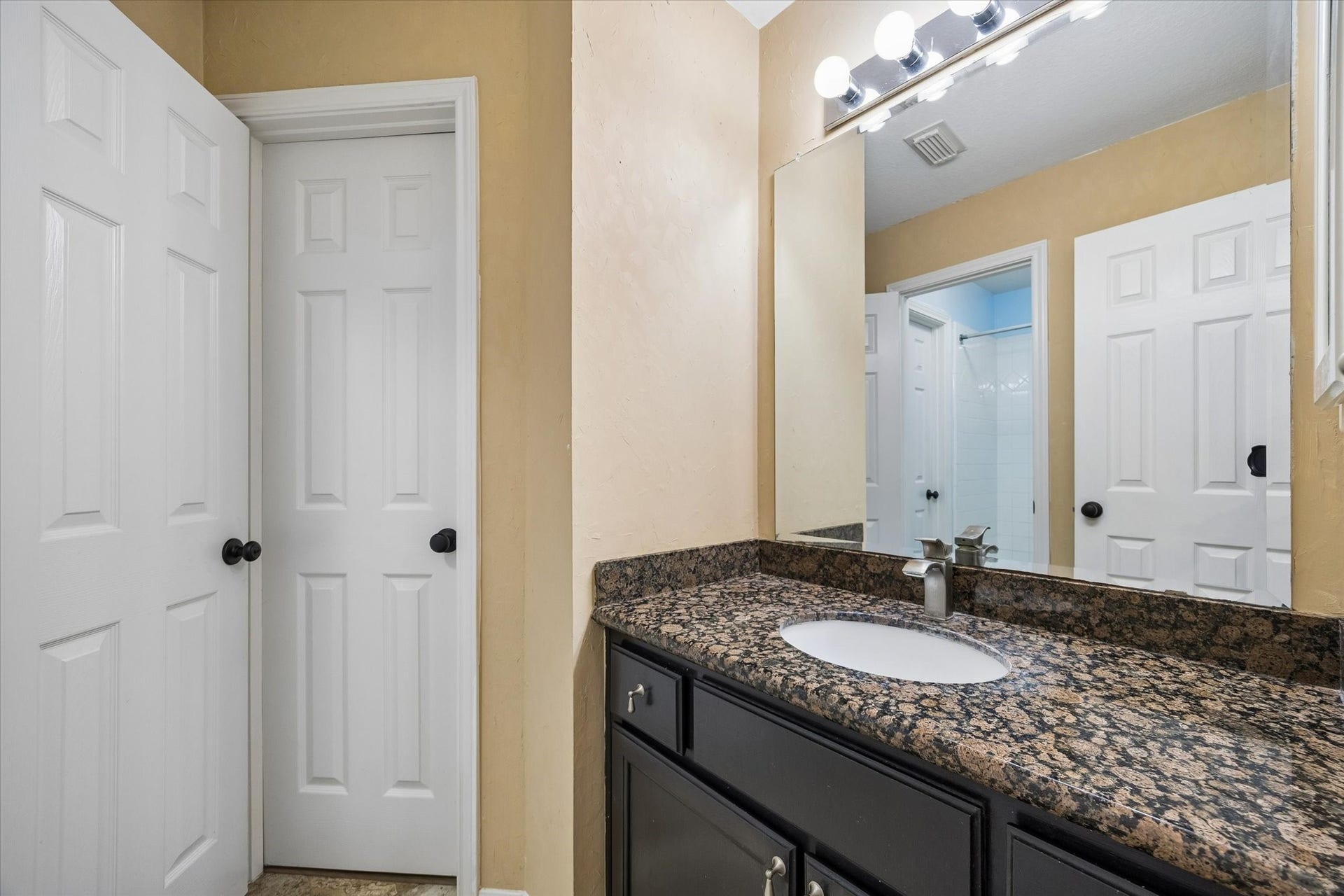 Thoughtfully designed to serve the upstairs secondary bedrooms, the Jack-and-Jill bathroom features a spacious vanity area and a tub/shower combination, blending style with everyday convenience.