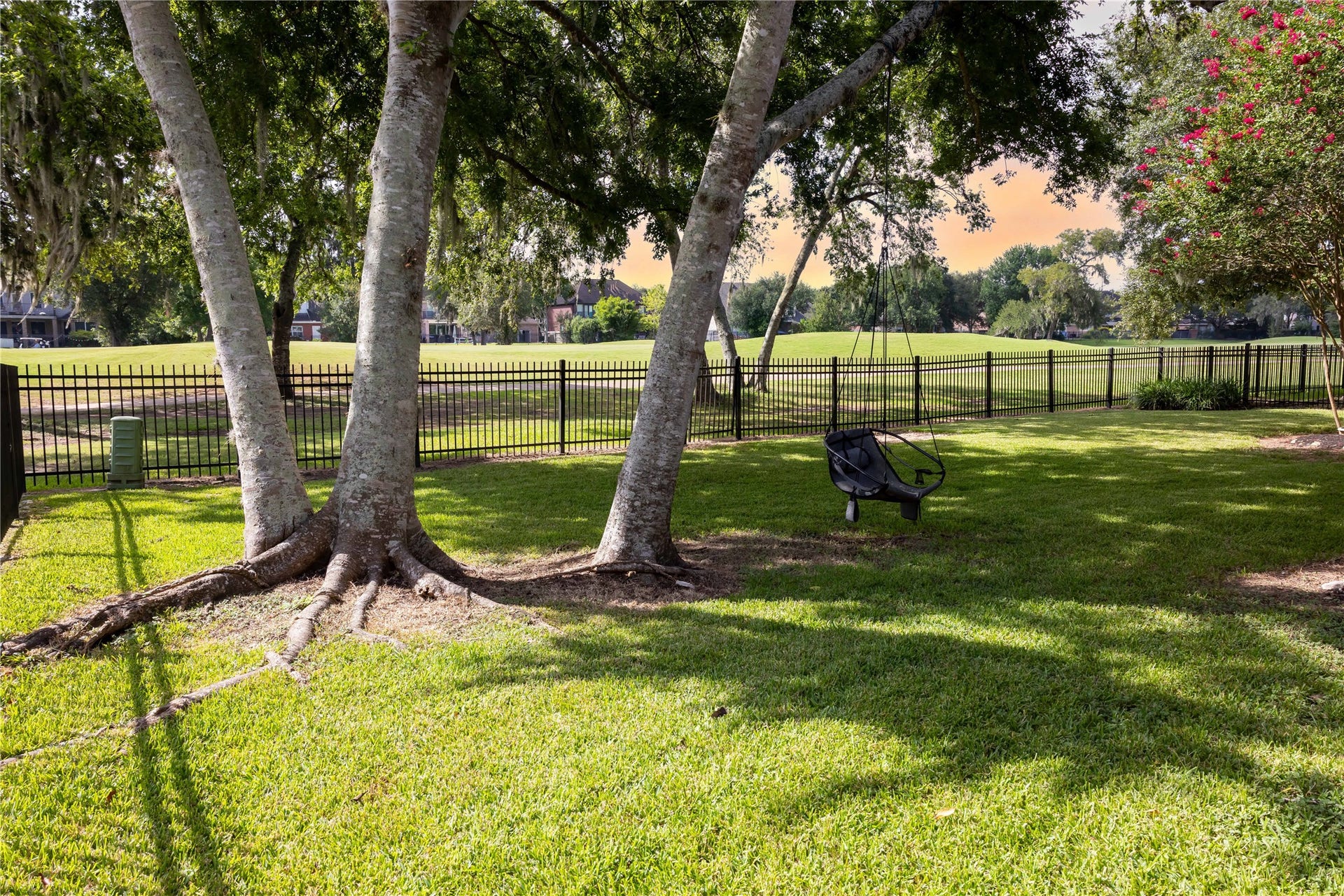 Mature shade trees frame the spacious backyard with beautiful views of the Greatwood Golf Course.