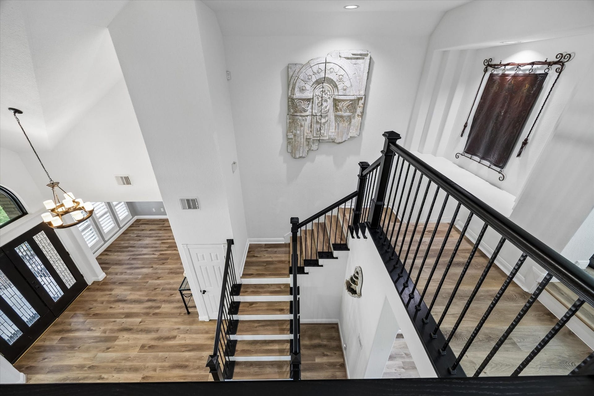Dramatic staircase with updated balusters and handrails adds timeless style and architectural appeal.