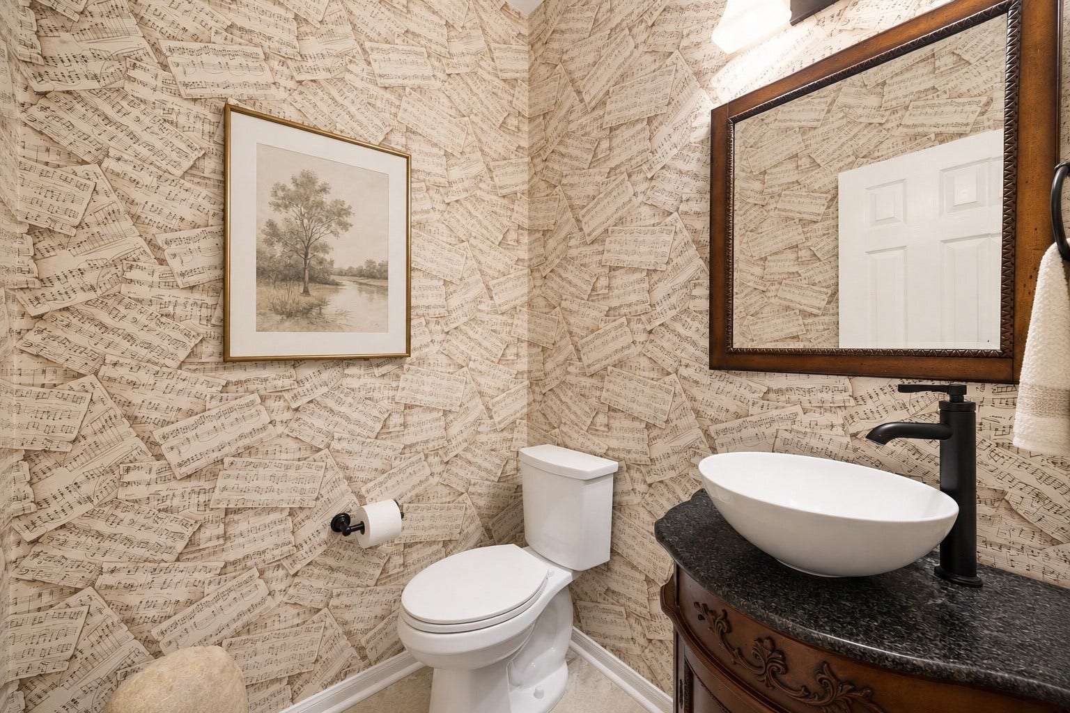 Conveniently located just off the entry, the elegant powder bath provides easy access for guests while offering both style and functionality.