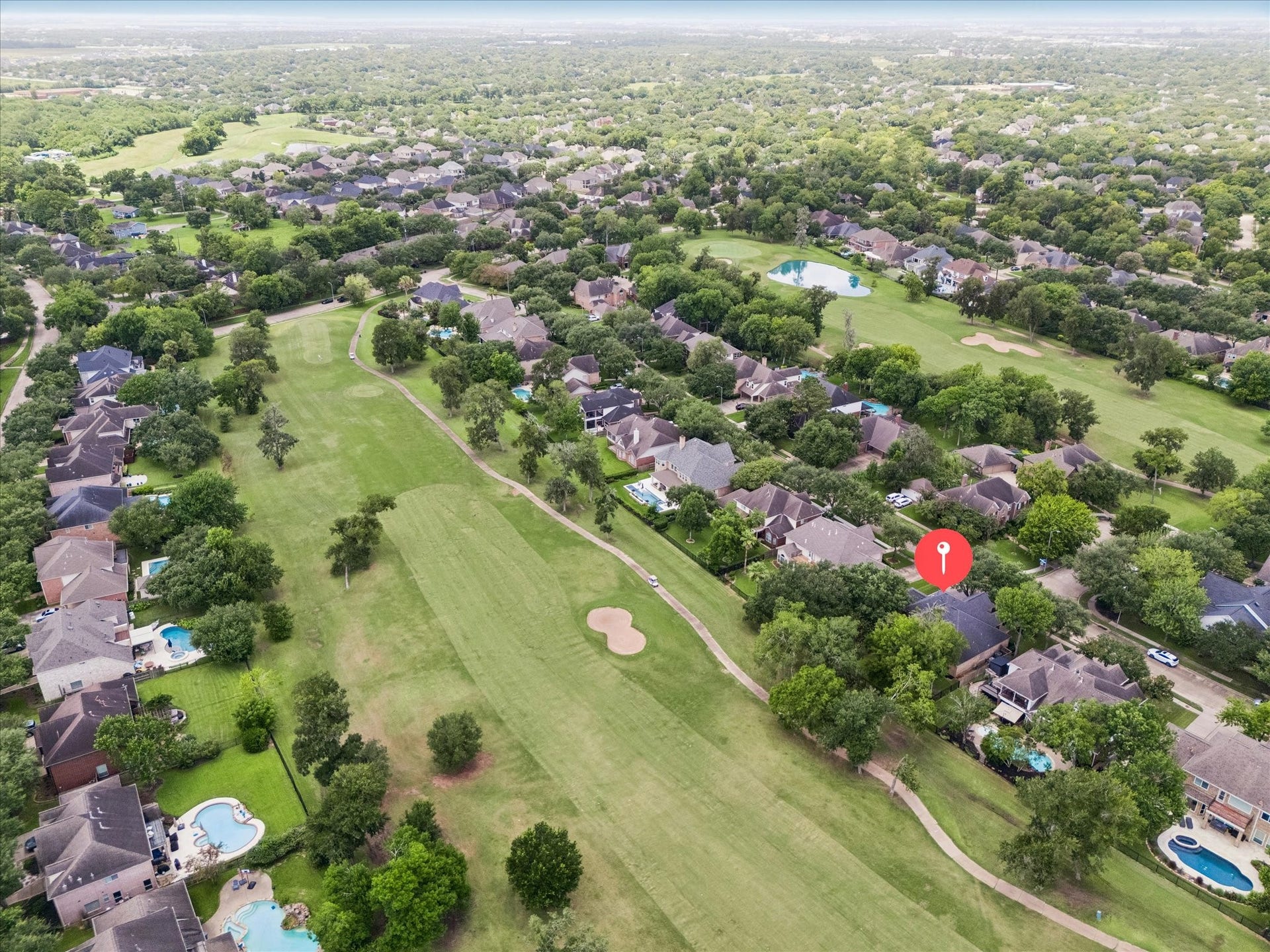 Experience the best of Greatwood from abovethis aerial view showcases the home's premier golf course setting and location, lush green fairways, and exceptional convenience to Highway 59, shopping, dining, and top-rated schools.