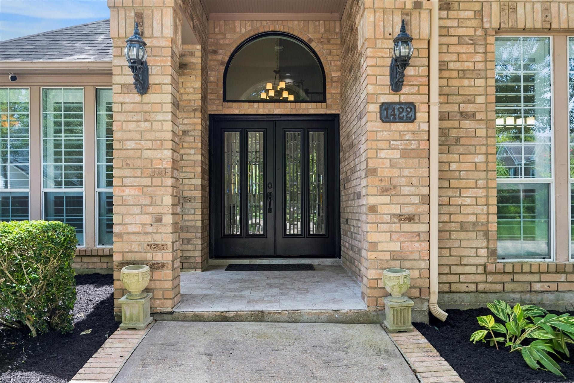 A striking leaded glass double-door entry creates a grand first impression and warmly welcomes family and friends.